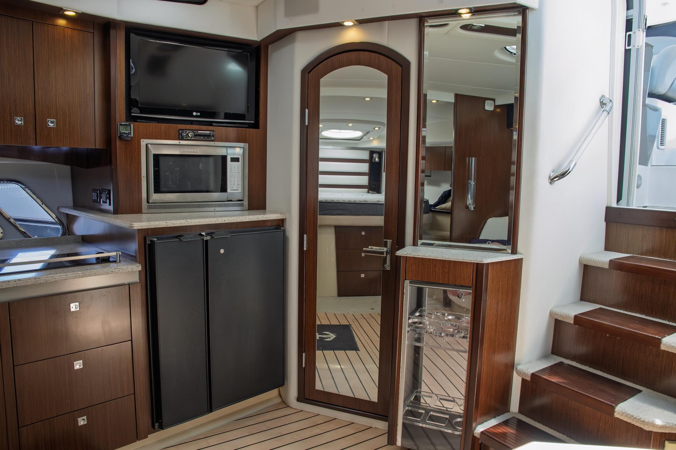 2011 Cruisers Yachts 420 Sport Coupe interior with kitchen, microwave, fridge, and stairs.