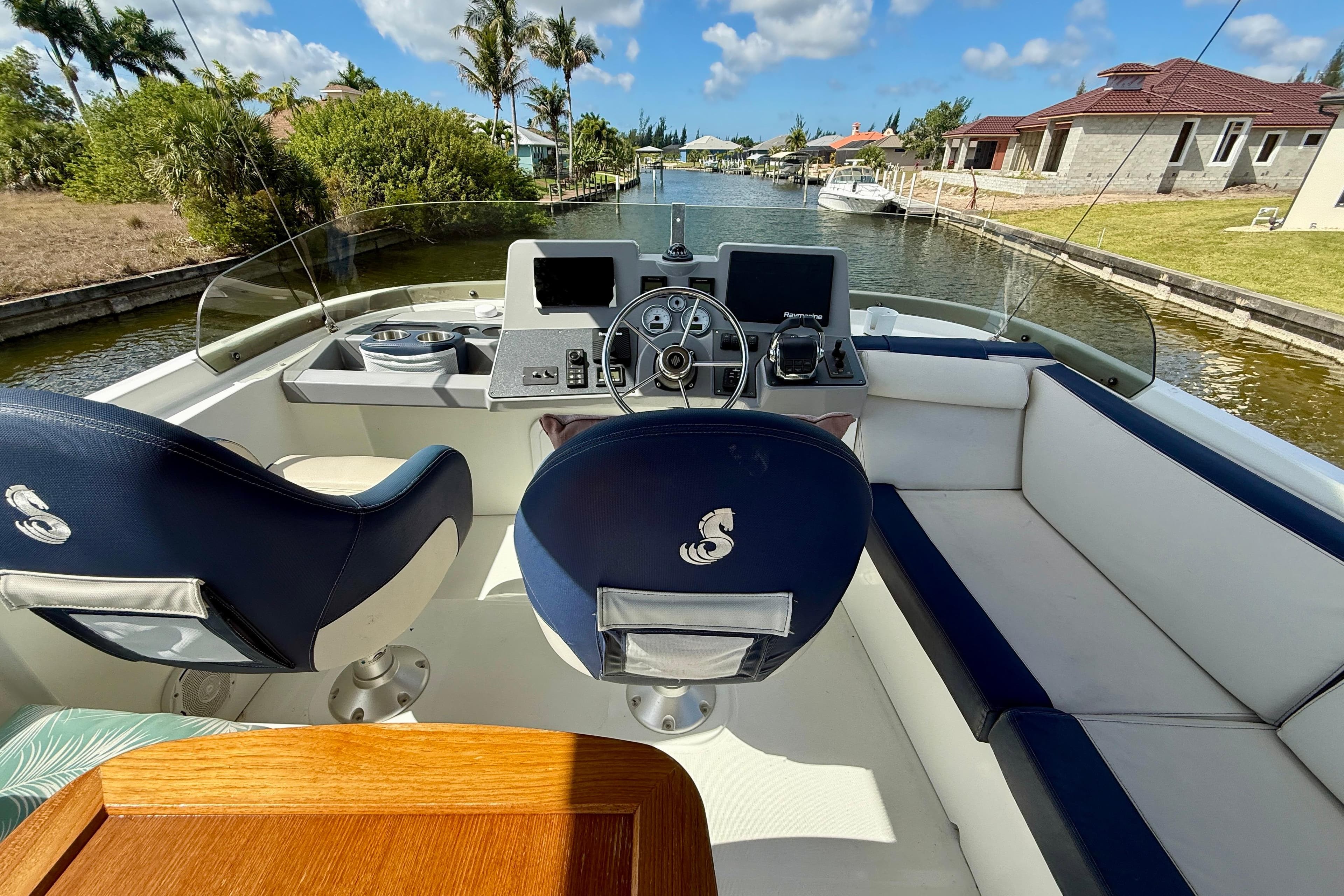 Cockpit view of 2020 Beneteau Swift Trawler 44, featuring helm and seating area.