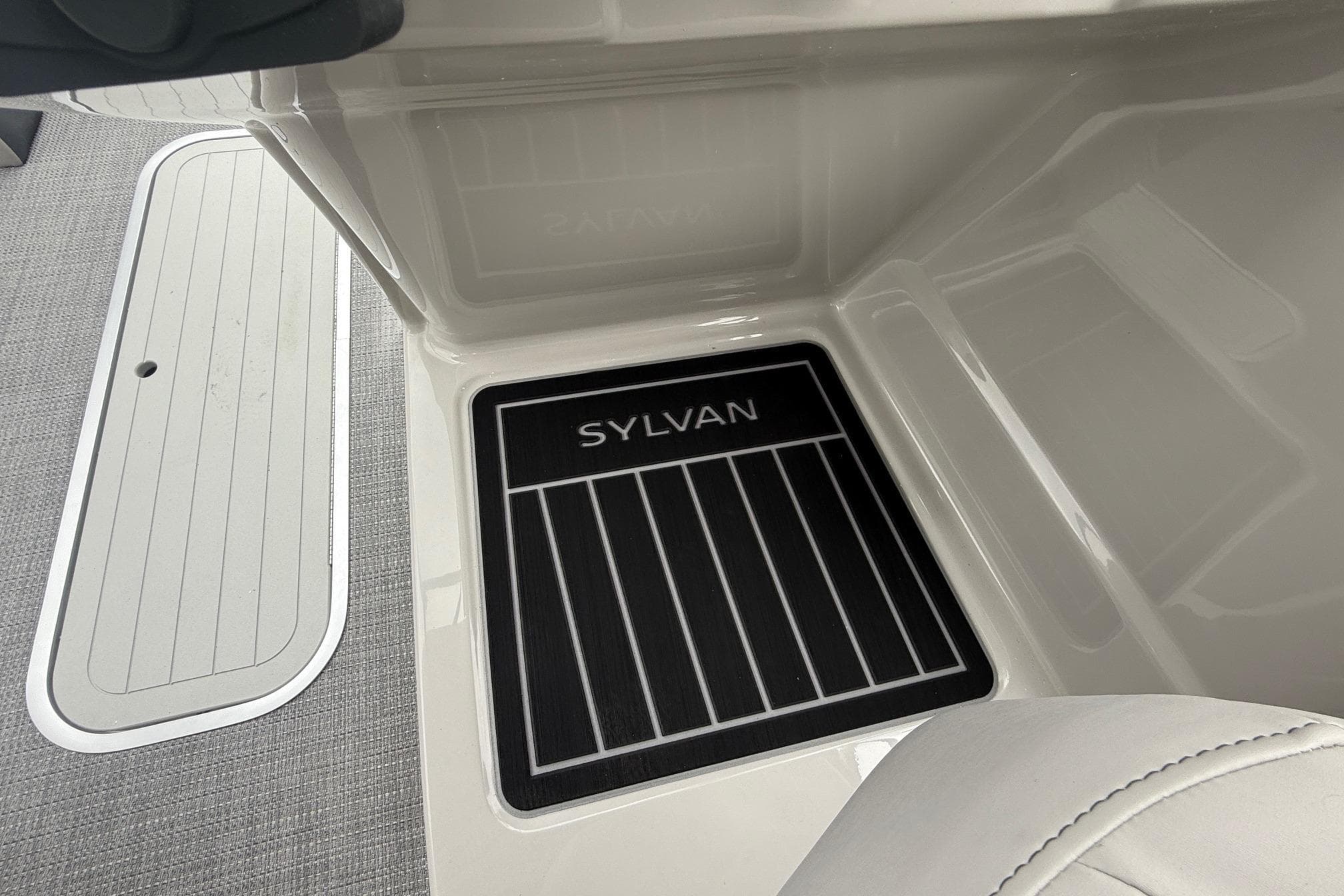 2026 Sylvan L-3 RLZ DH boat interior with branded floor mat.