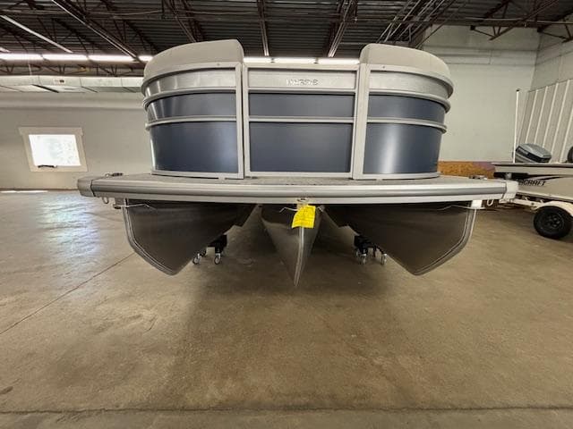 2025 Harris Cruiser 230 CWDH pontoon boat in a warehouse setting.