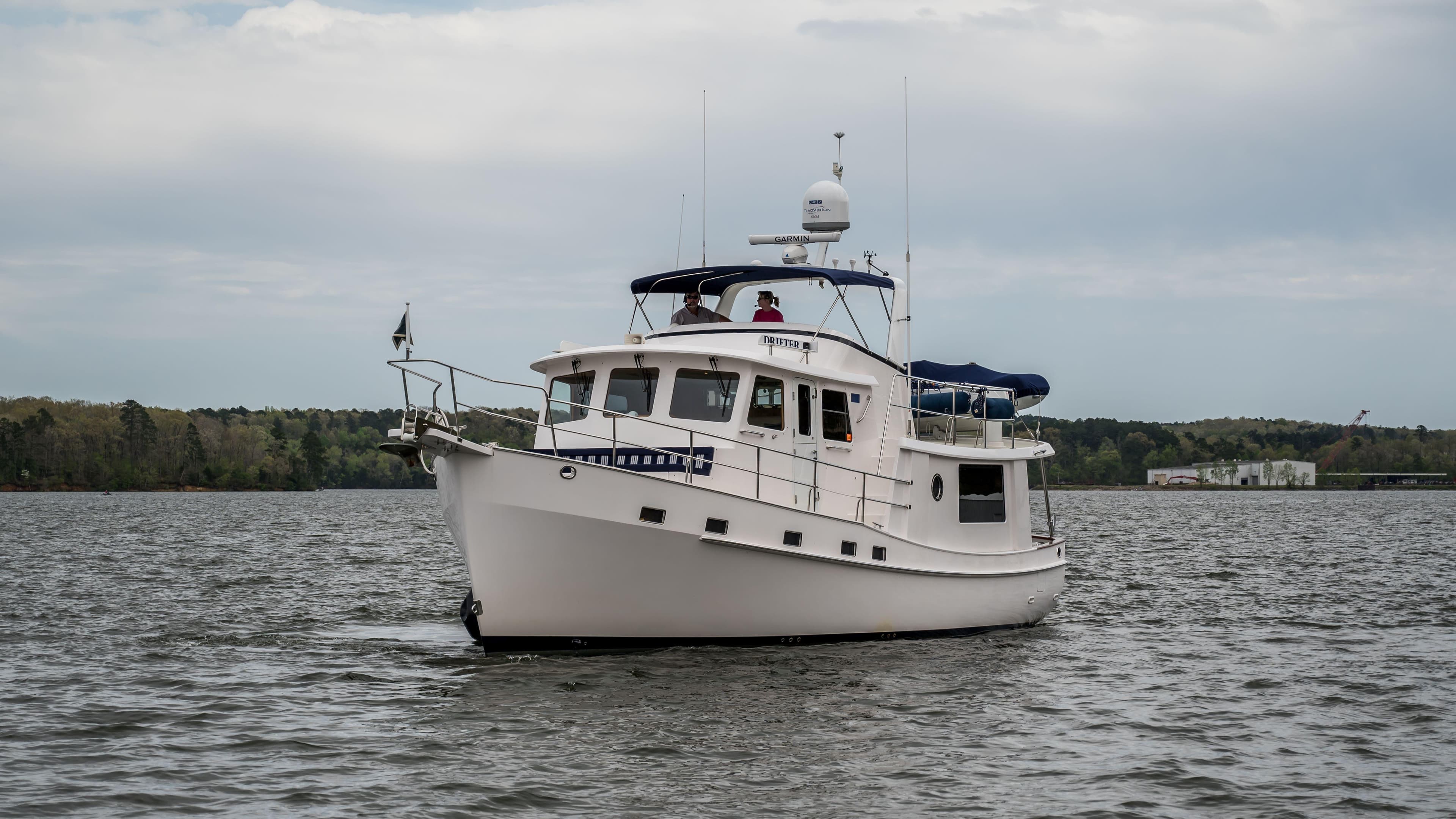 2025 Krogen 44 AE yacht cruising on a calm lake.