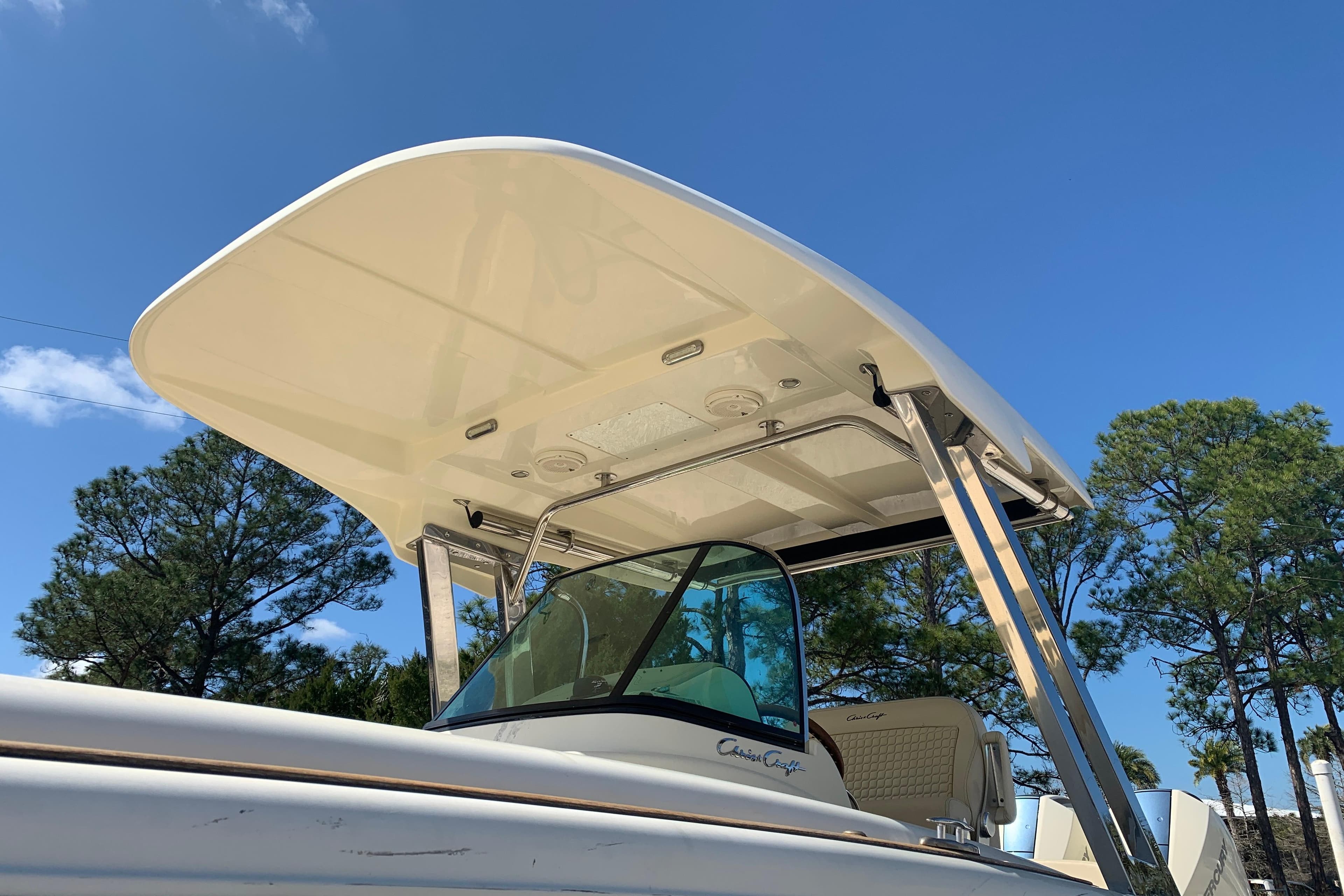 2019 Chris-Craft Catalina 27 boat with T-top against clear blue sky.