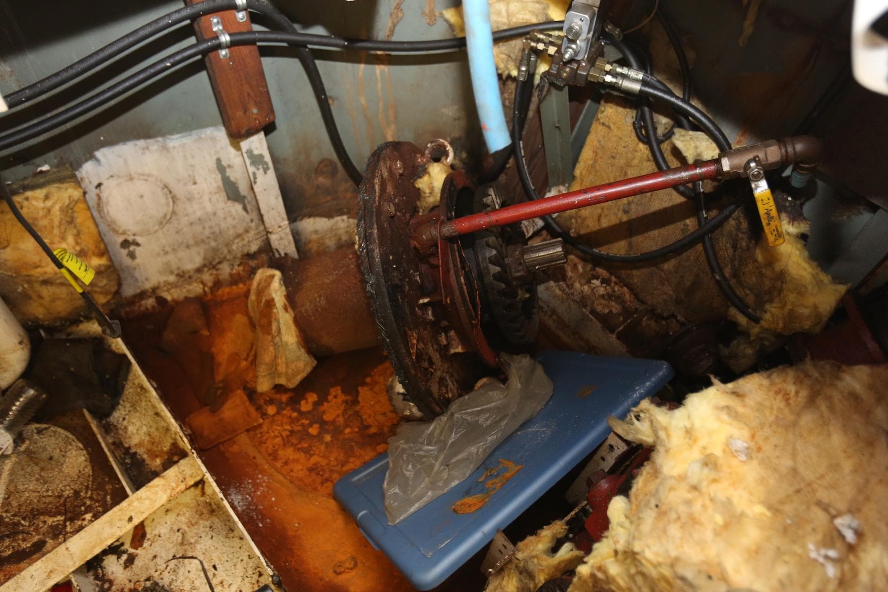 Engine room of 1988 Winston Knauss 64 Party Boat, showing rust and mechanical components.