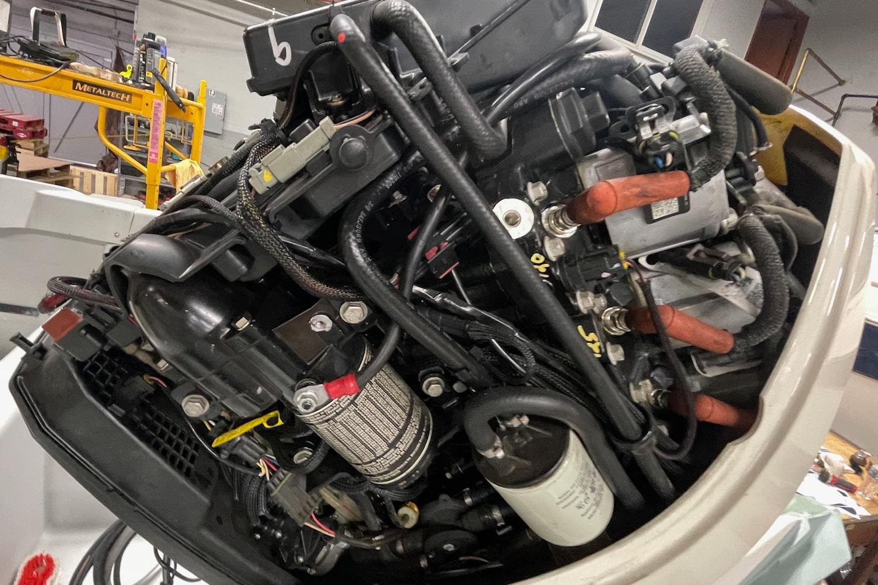 Close-up of a 1995 Boston Whaler Justice boat engine in a workshop setting.