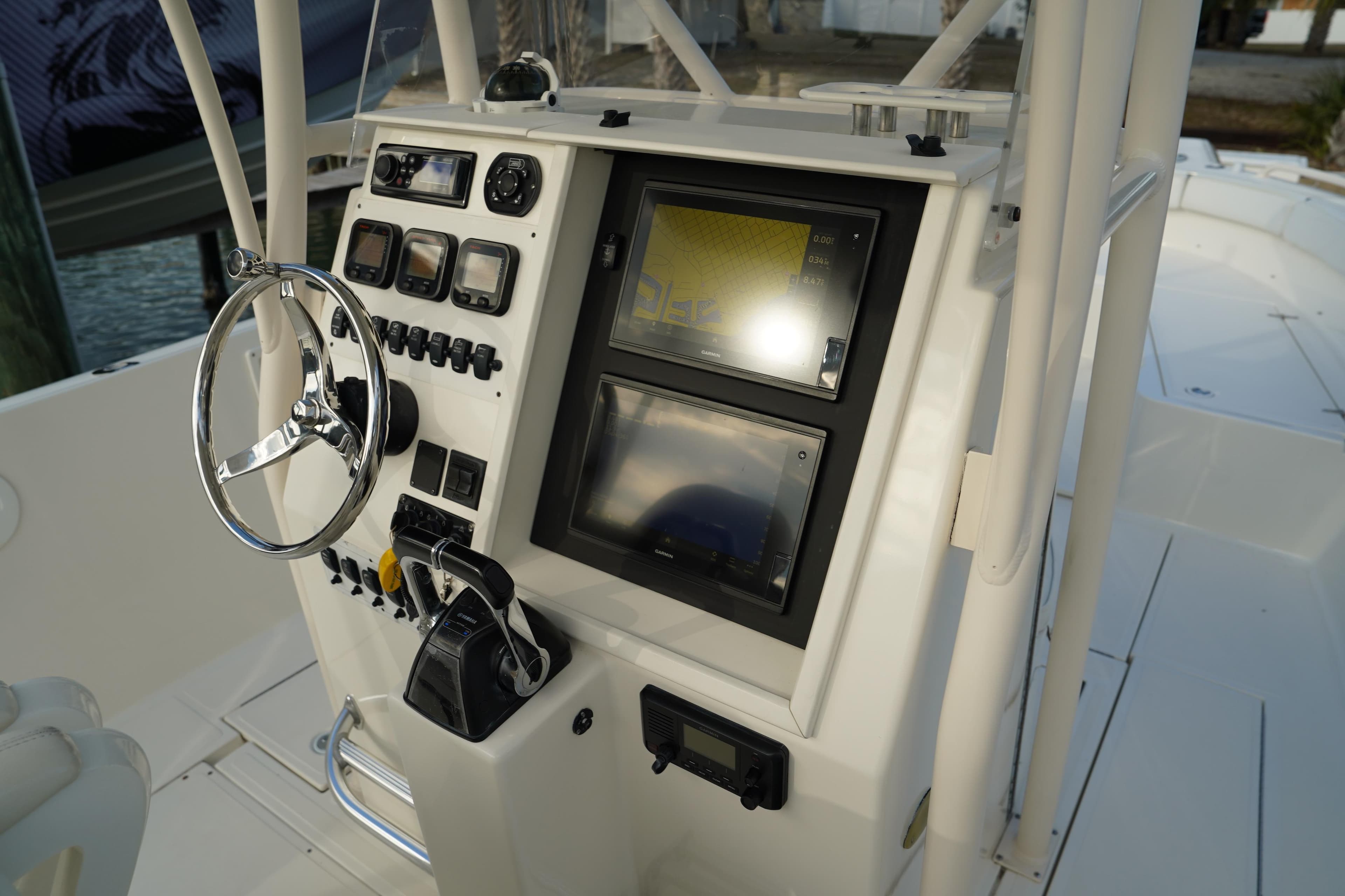 2013 Stamas 317 Tarpon boat console with steering wheel and navigation screens.