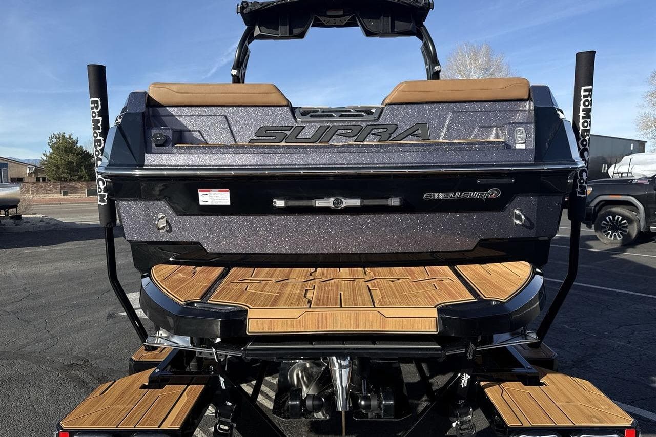 2026 Supra SE 550 boat rear view with teak deck and SwellSurf system.