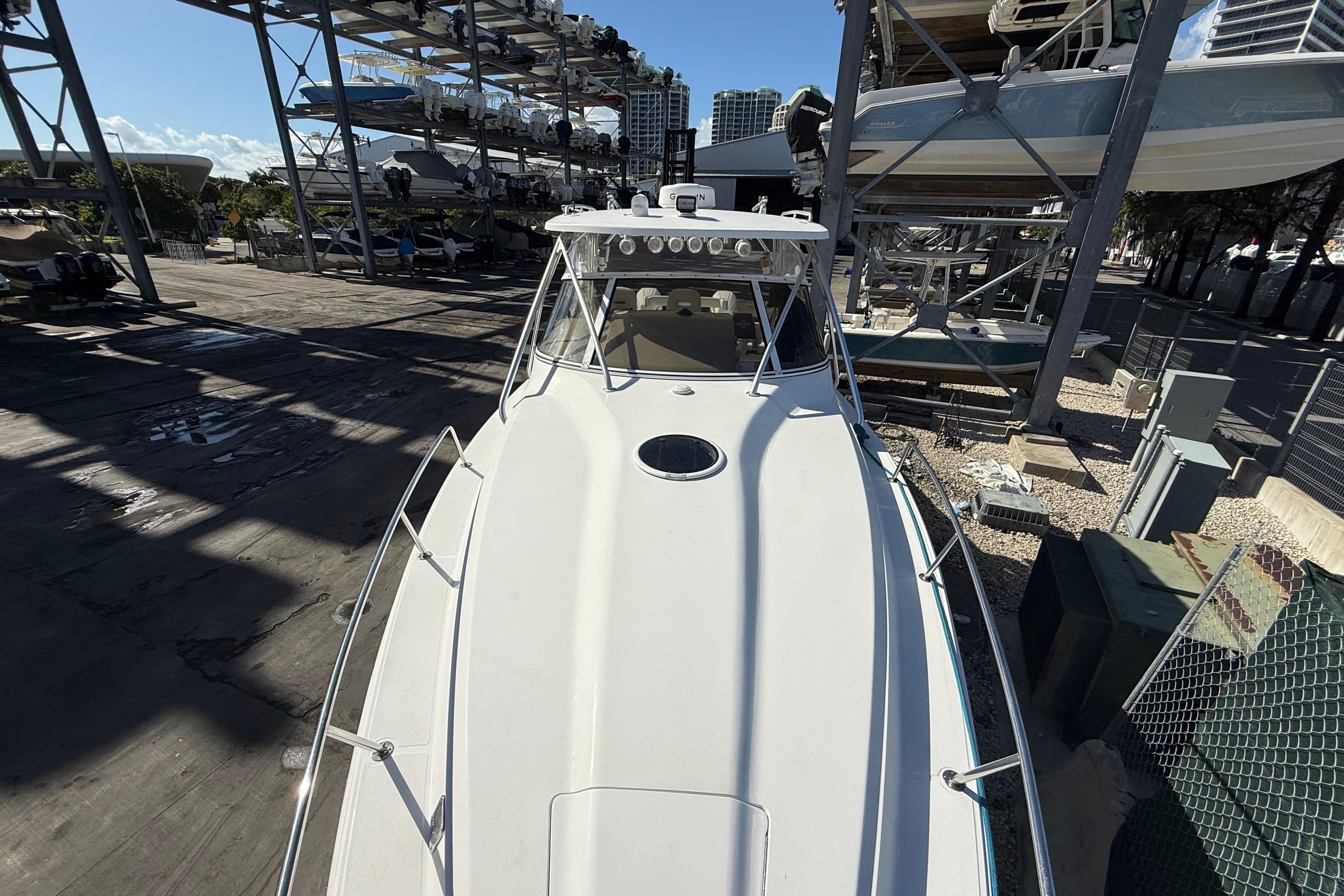 2017 Fountain 38 Sportfish Cruiser docked in a marina with stacked boats.