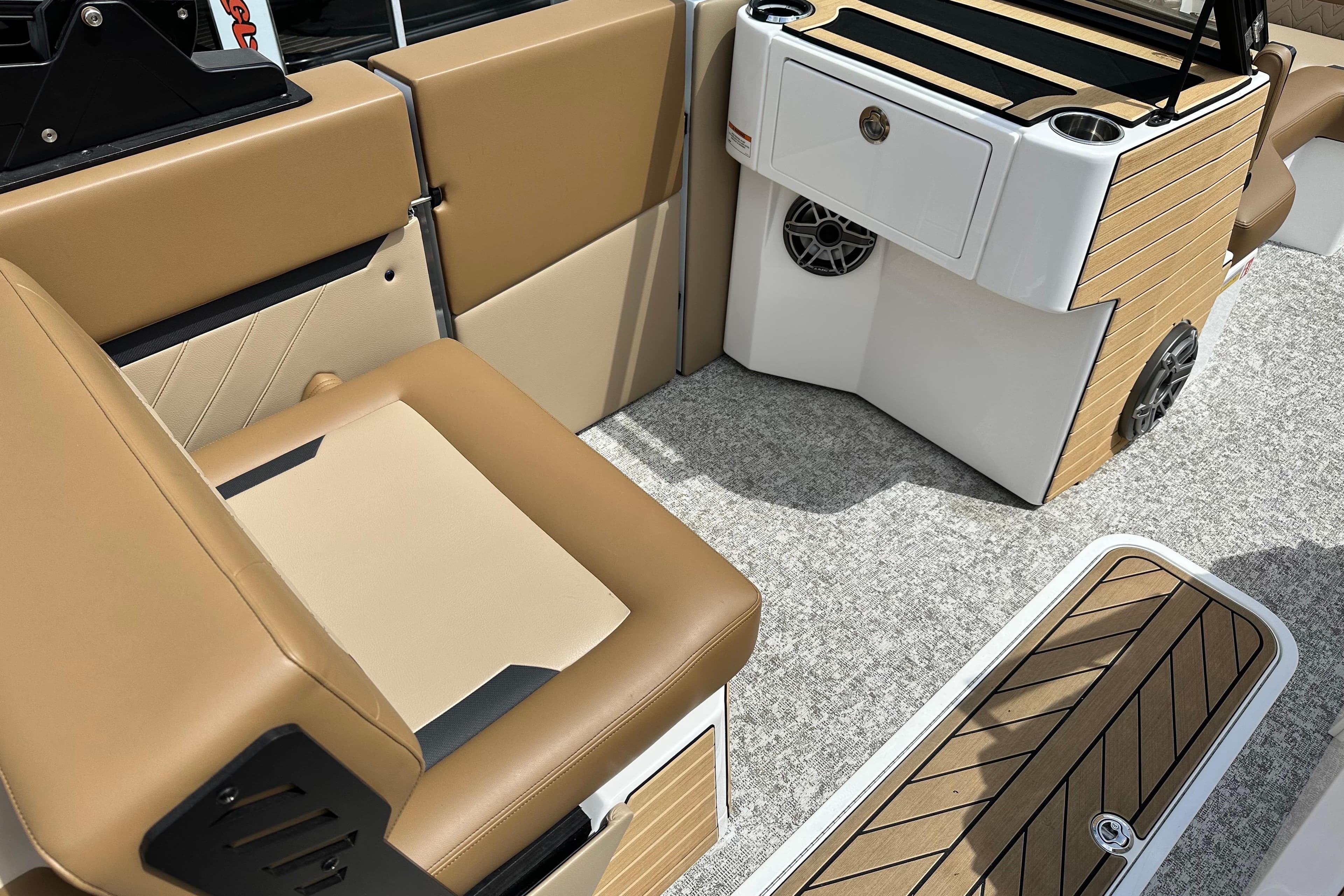 2026 Revel RS25 boat interior with tan seating and modern console design.