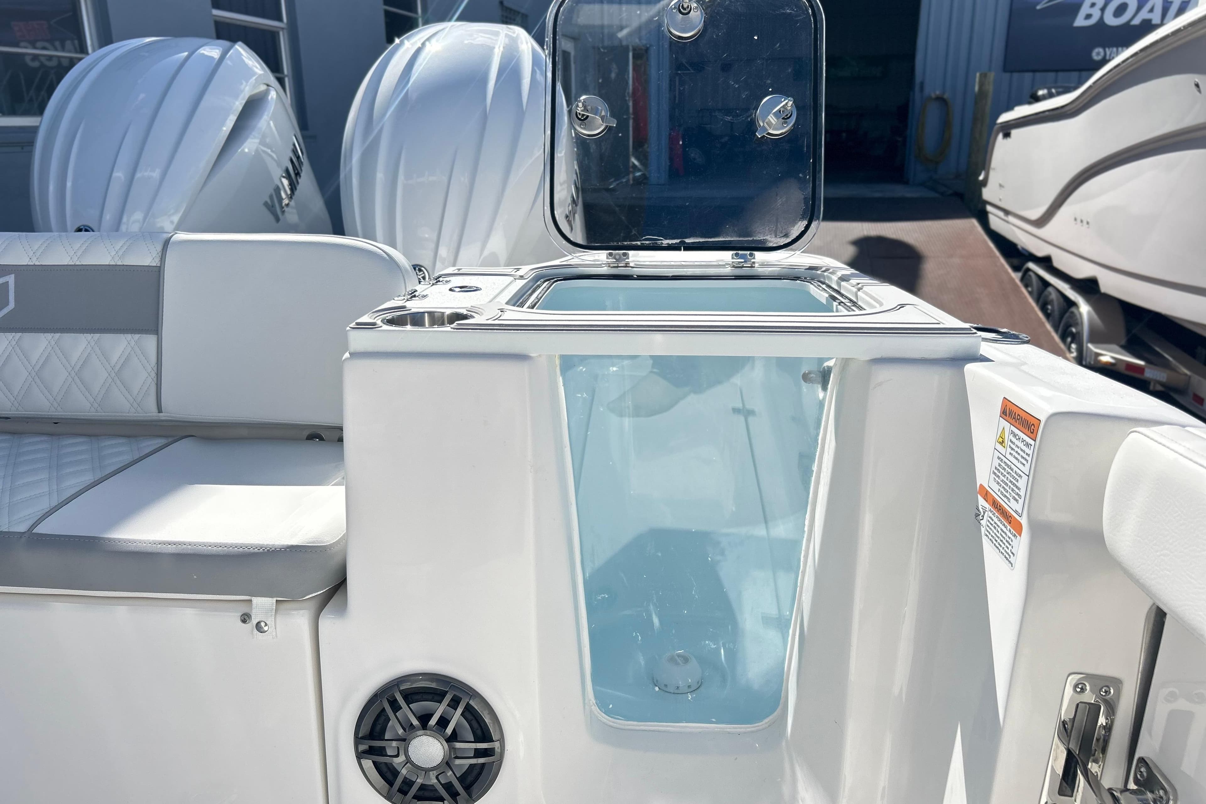 2026 Sea Fox 268 Commander boat interior with open storage compartment and Yamaha engines.