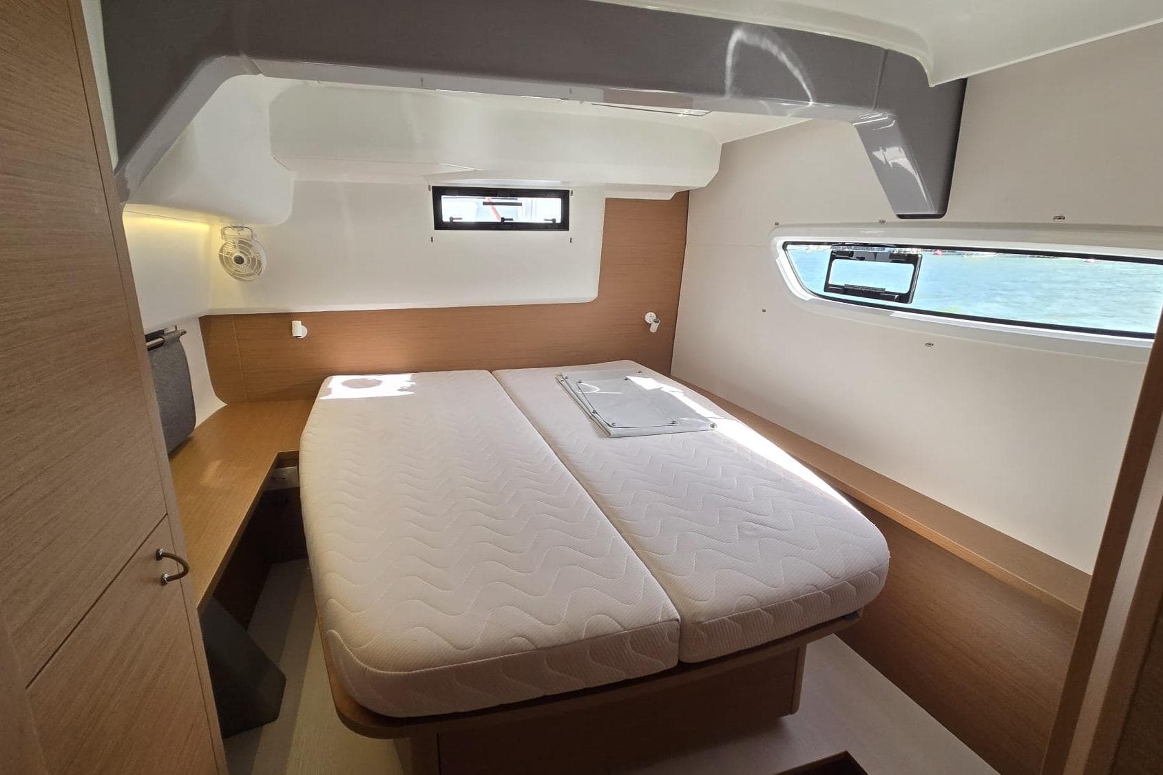 Luxurious cabin interior of 2025 Excess 14 yacht with double bed and ocean view.