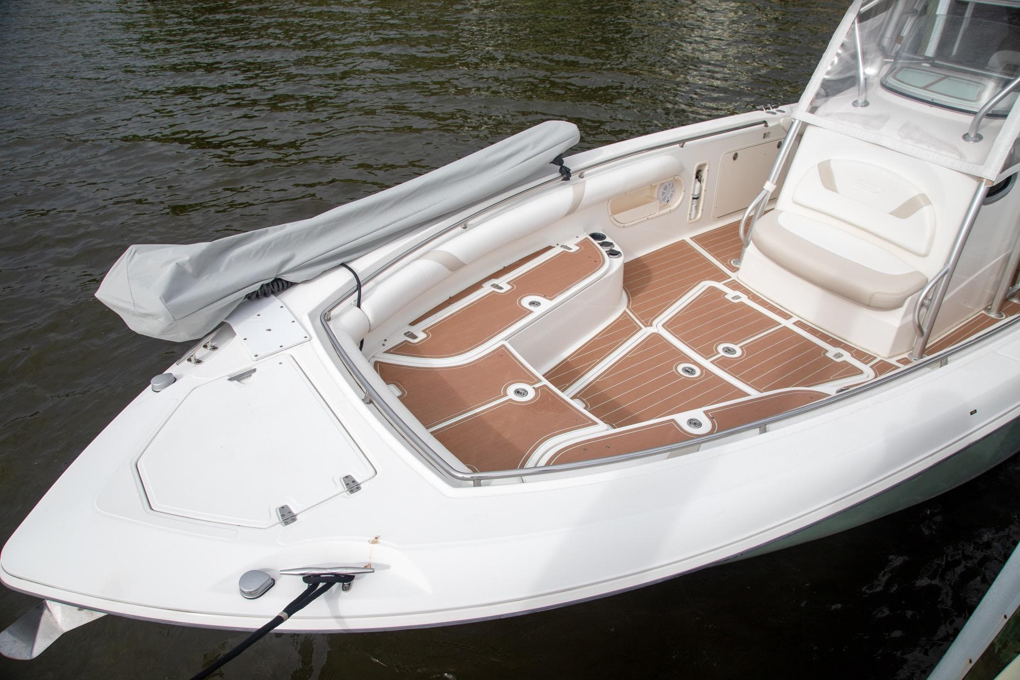 2006 Boston Whaler 320 Outrage boat with spacious deck and seating, docked on water.