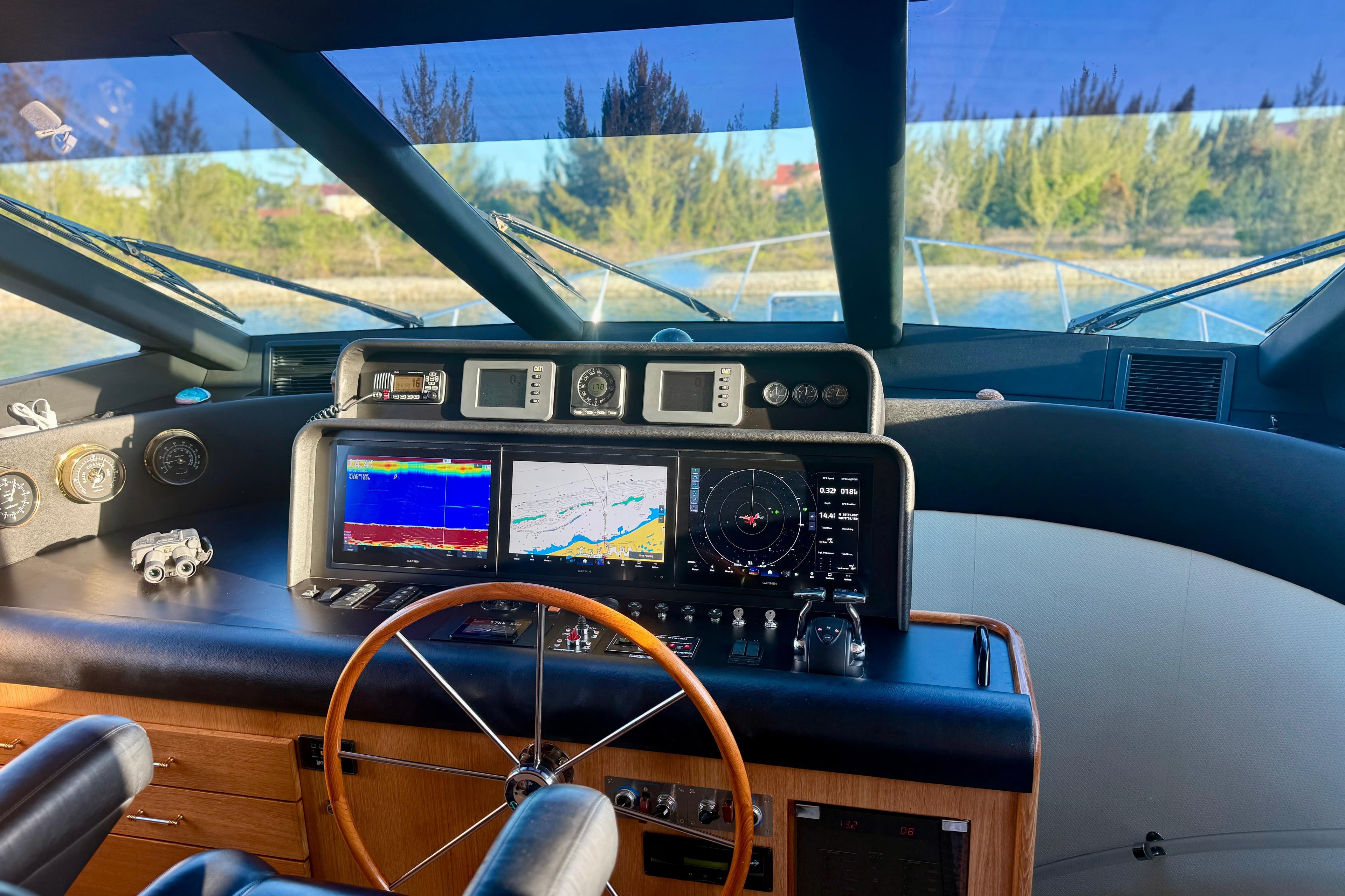 Cockpit of 2001 Pacific Mariner 65 Motoryacht with navigation screens and steering wheel.