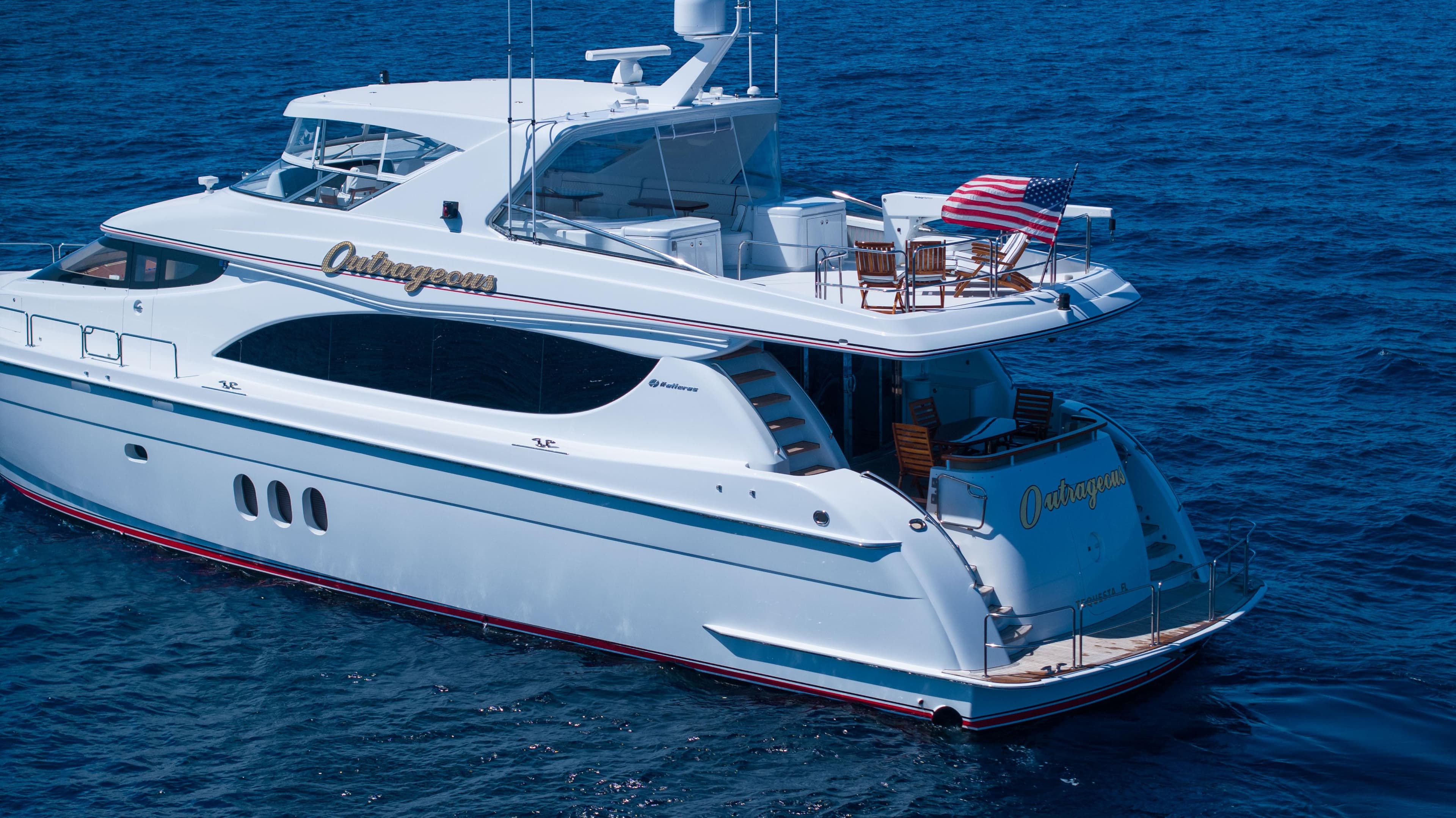 2005 Hatteras 80 Motor Yacht cruising on blue ocean waters.