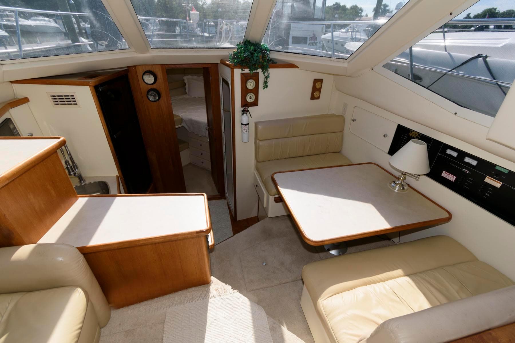 Interior of 1997 Carver 400 Cockpit Motor Yacht with seating area and table.