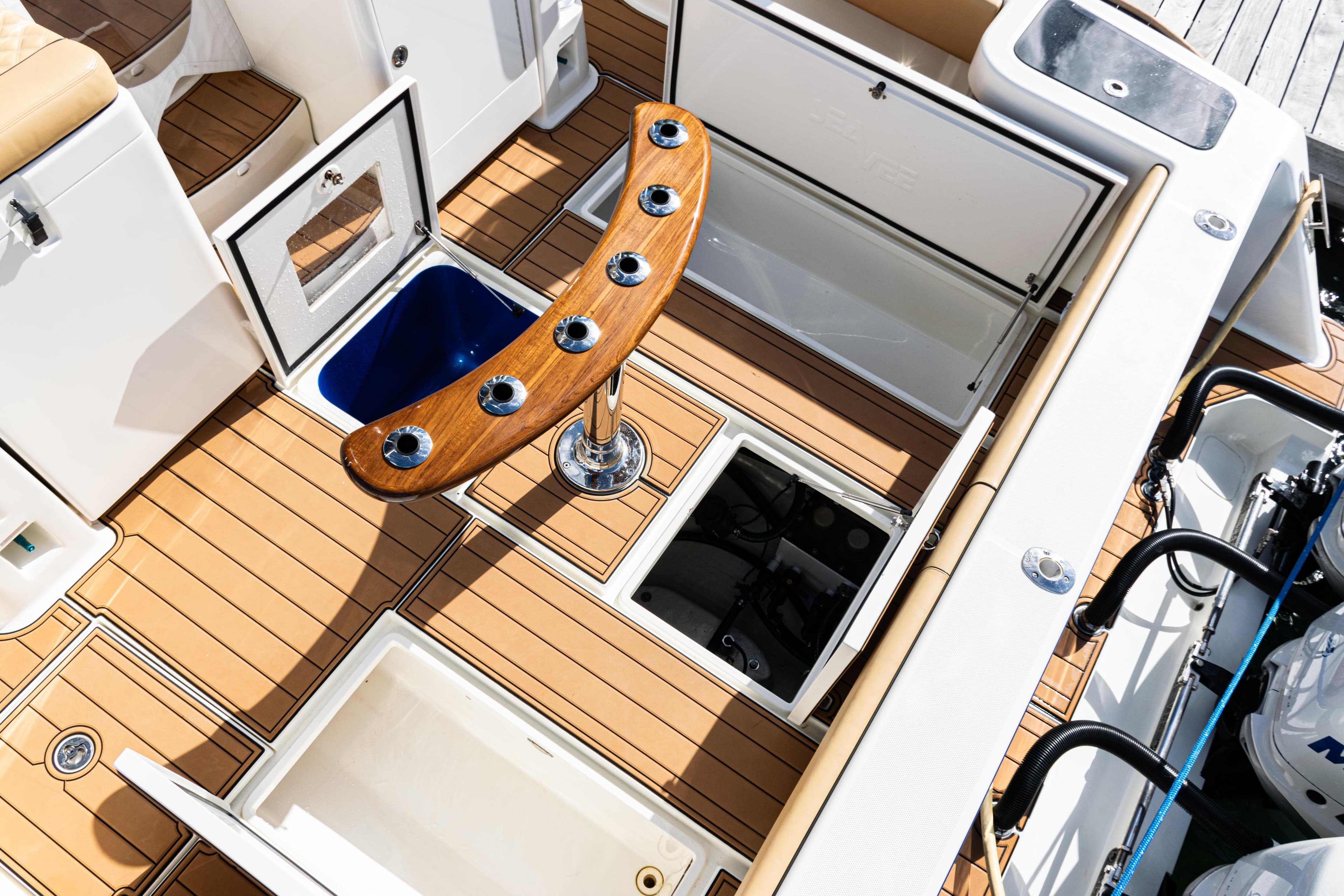 2016 SeaVee 430 boat deck with storage compartments and rod holders.