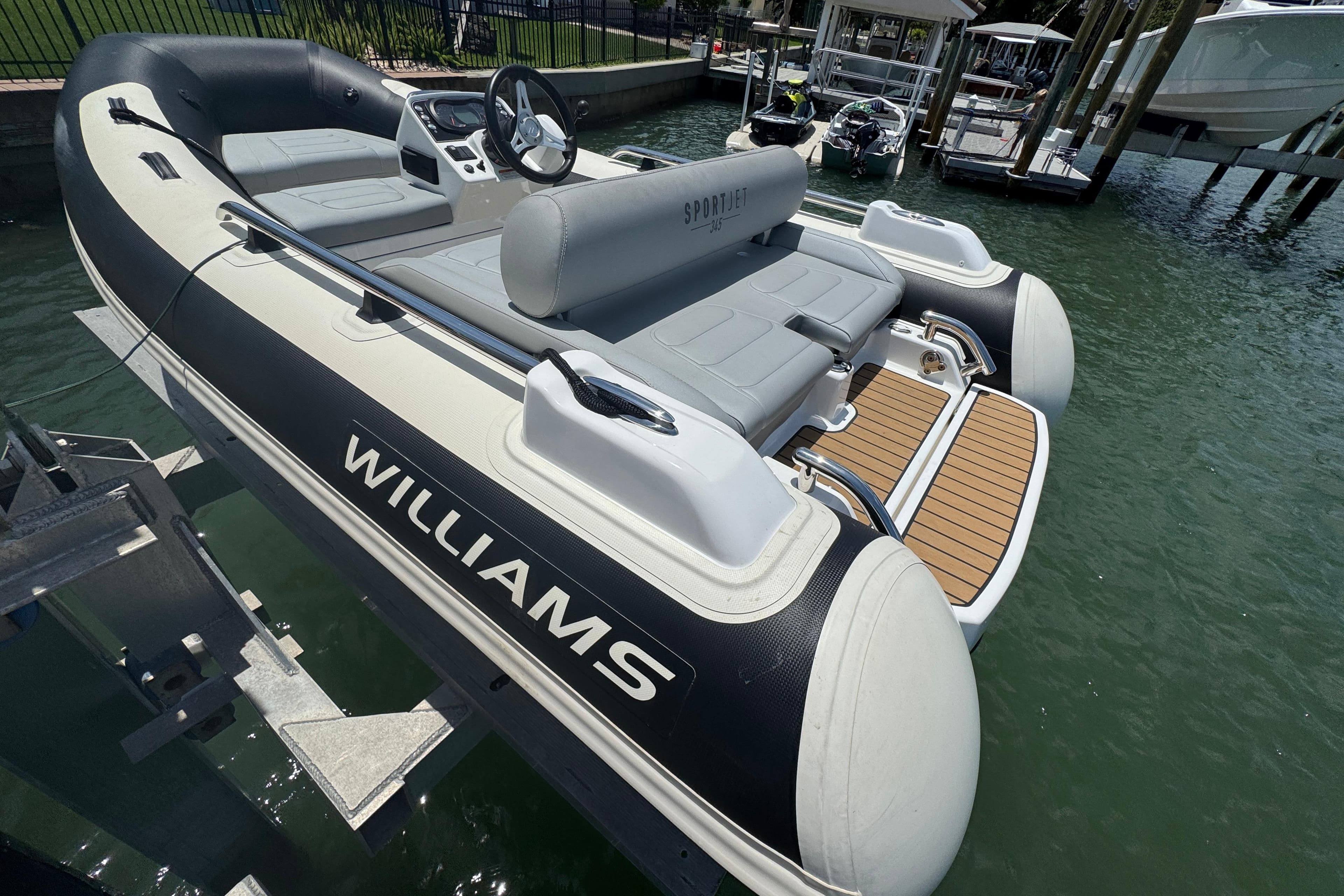 2025 Williams Jet Tenders Sportjet 345 docked, showcasing sleek design and modern features.