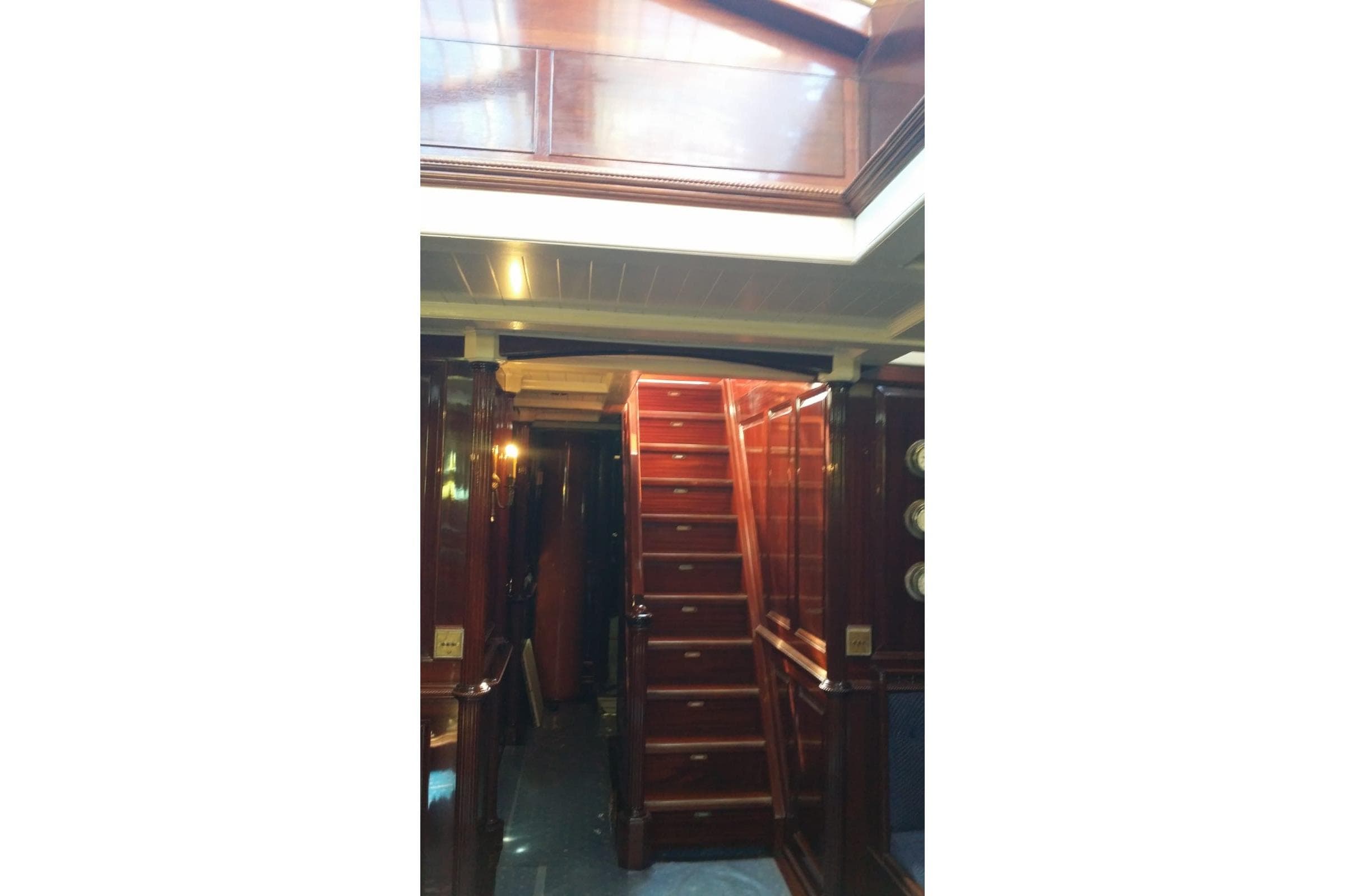 Interior of 1930 Frederikksund Gaff Topsail Schooner with polished wooden staircase.