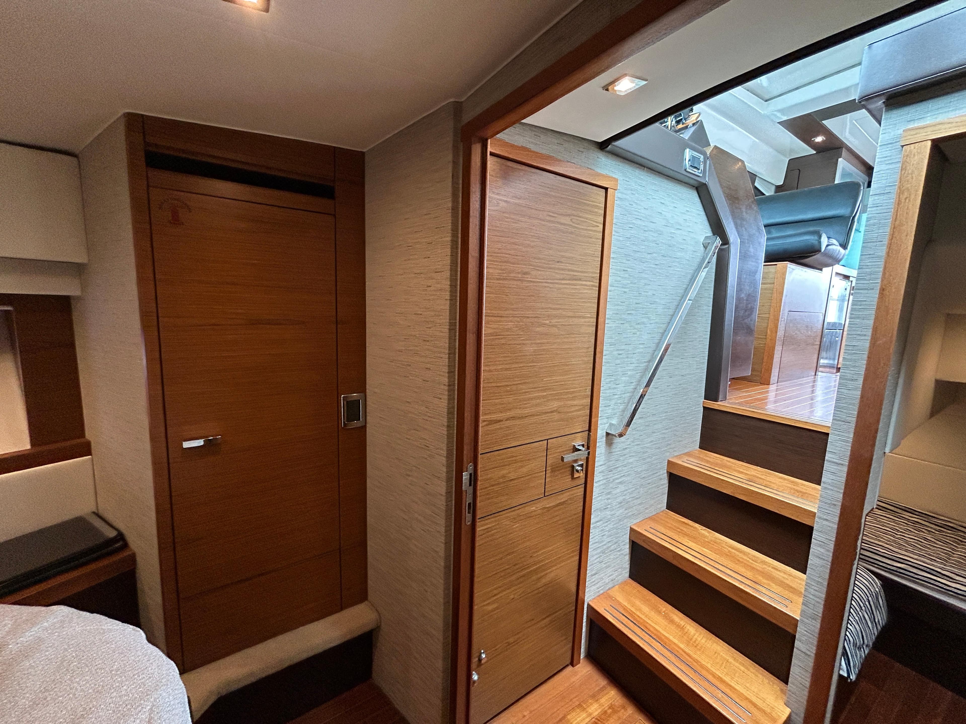 Interior of 2015 Tiara Yachts C44 Coupe, featuring wooden doors and stairs.