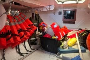 Storage area in a 1996 KenCraft Down East Express 35 with life jackets and safety gear.