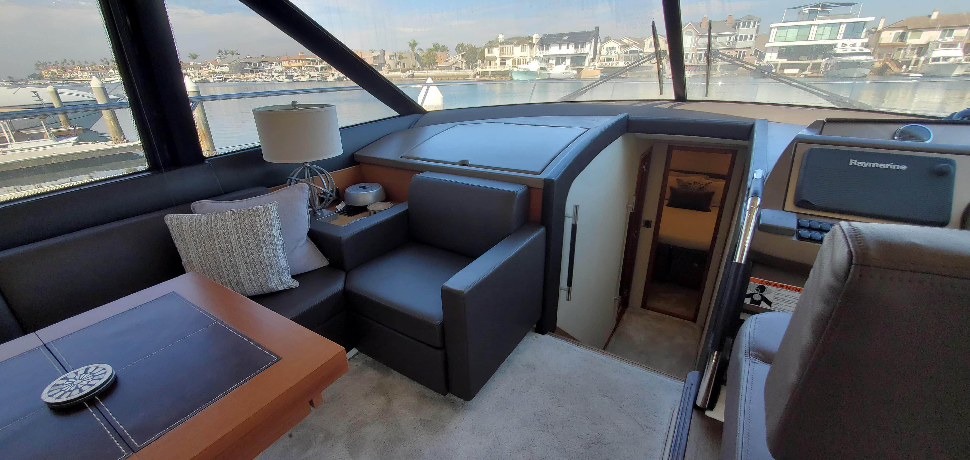 Luxurious interior of 2017 Prestige 560 Flybridge yacht with modern seating and navigation equipment.