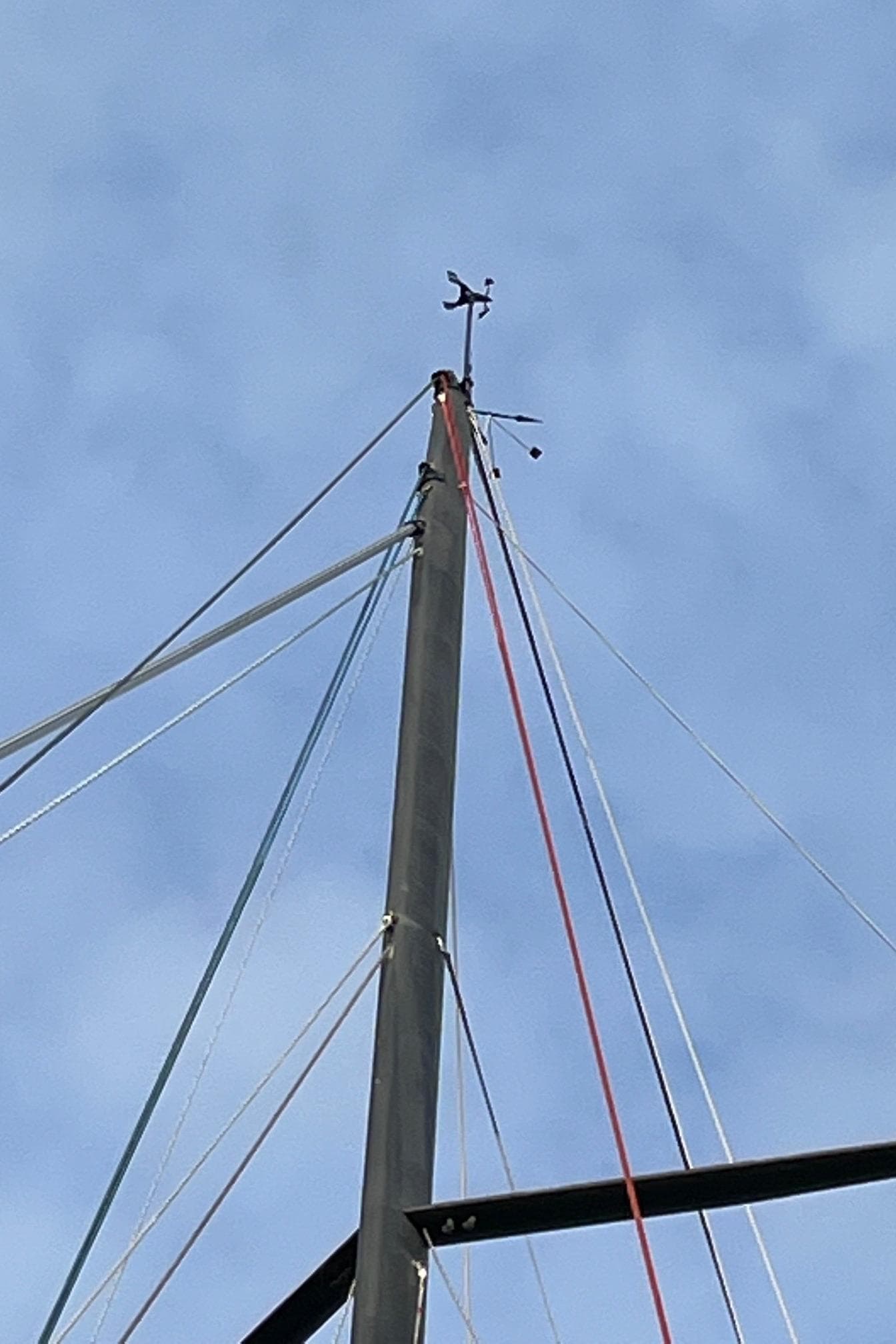 Mast of 2007 Akilaria MK1 Class 40 yacht against blue sky.