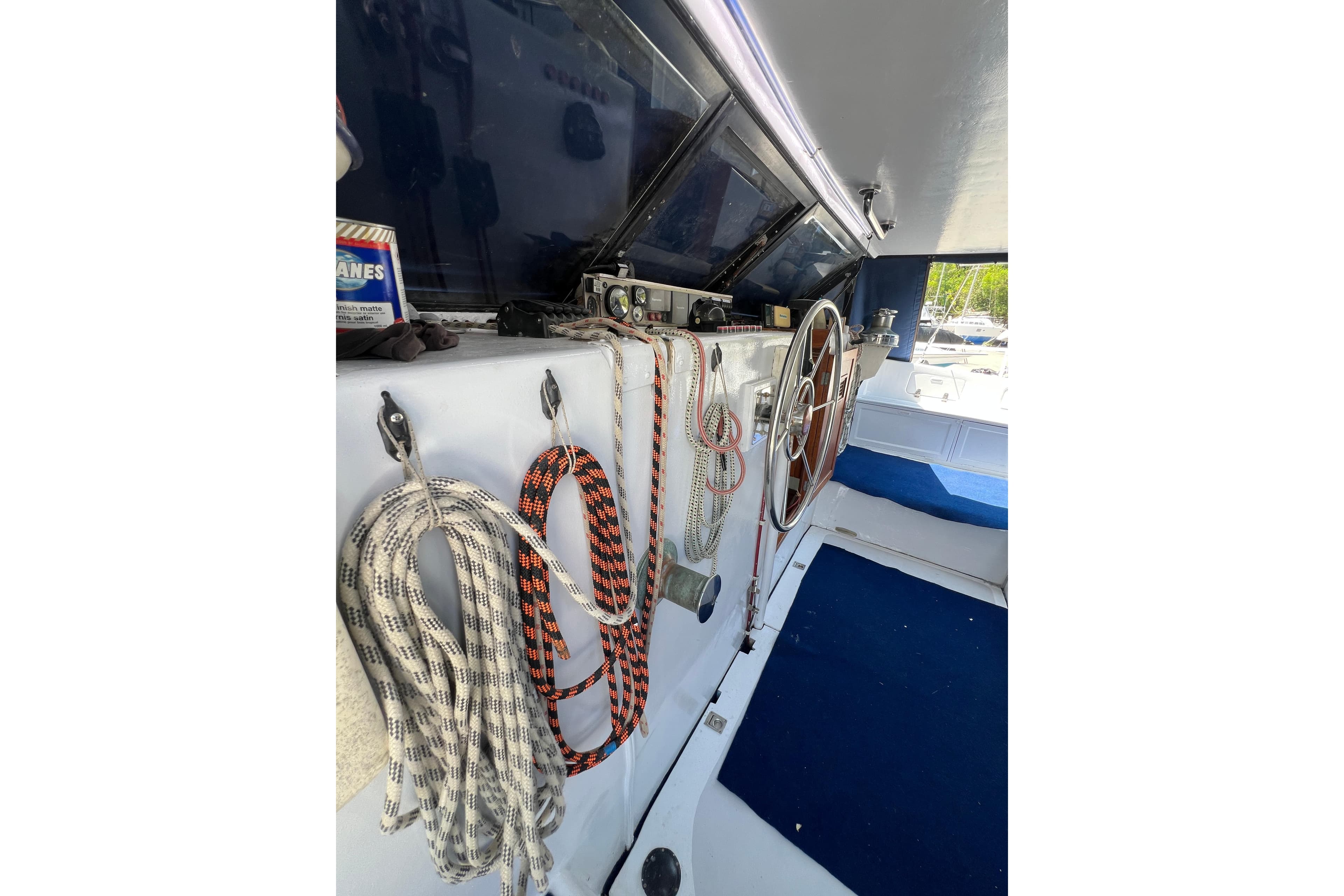 Interior of 1989 Beuhler Custom Trimaran with ropes and steering wheel.
