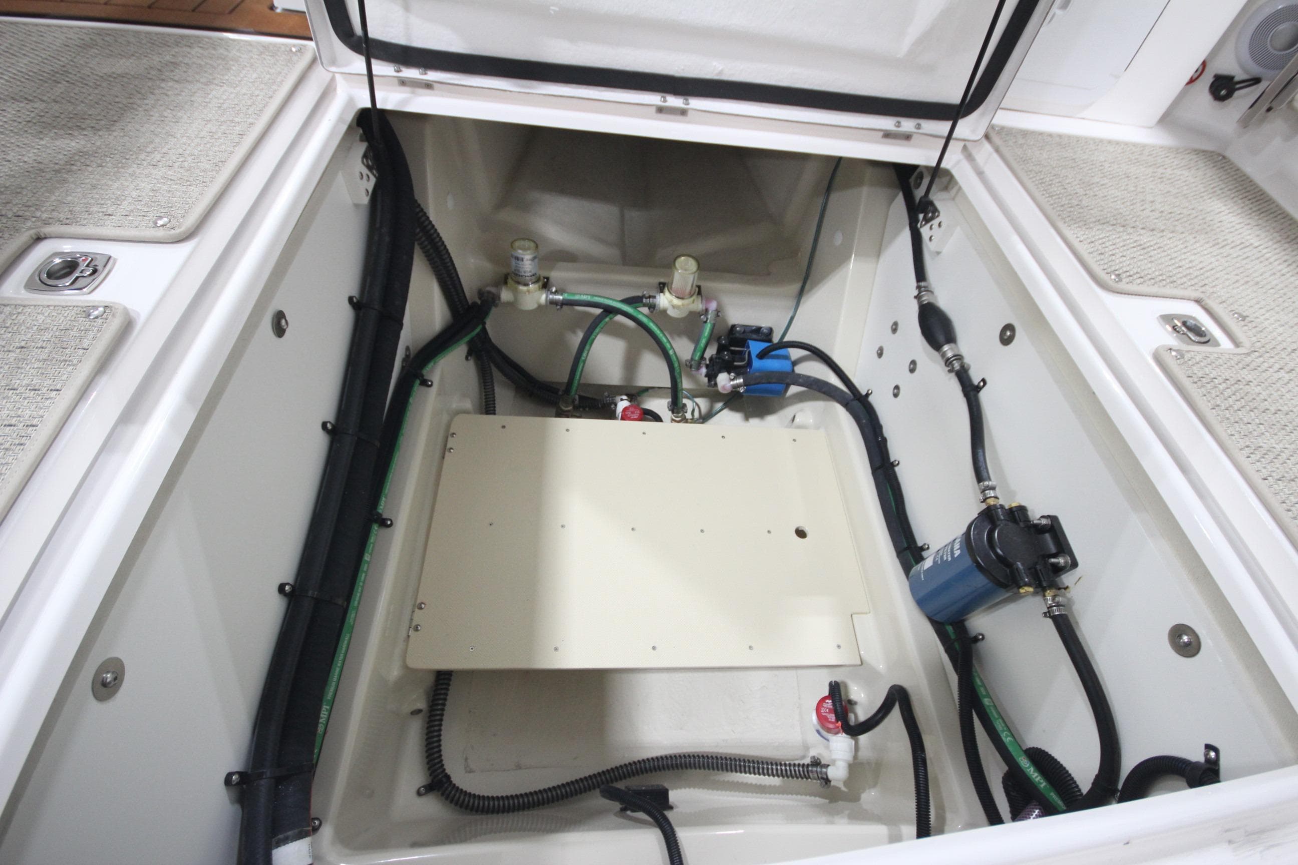 2026 Ranger Tugs R-25 engine compartment with visible wiring and components.
