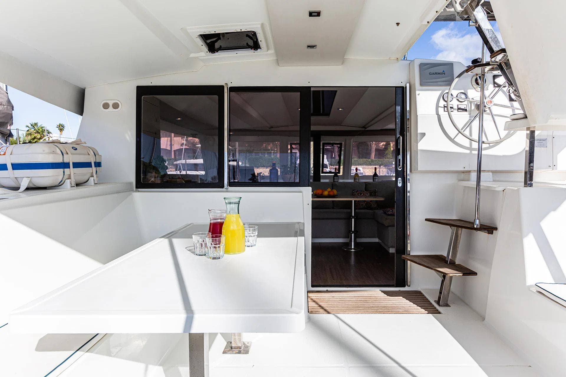 2019 Fountaine Pajot Lucia 40 catamaran interior with table, drinks, and helm station.