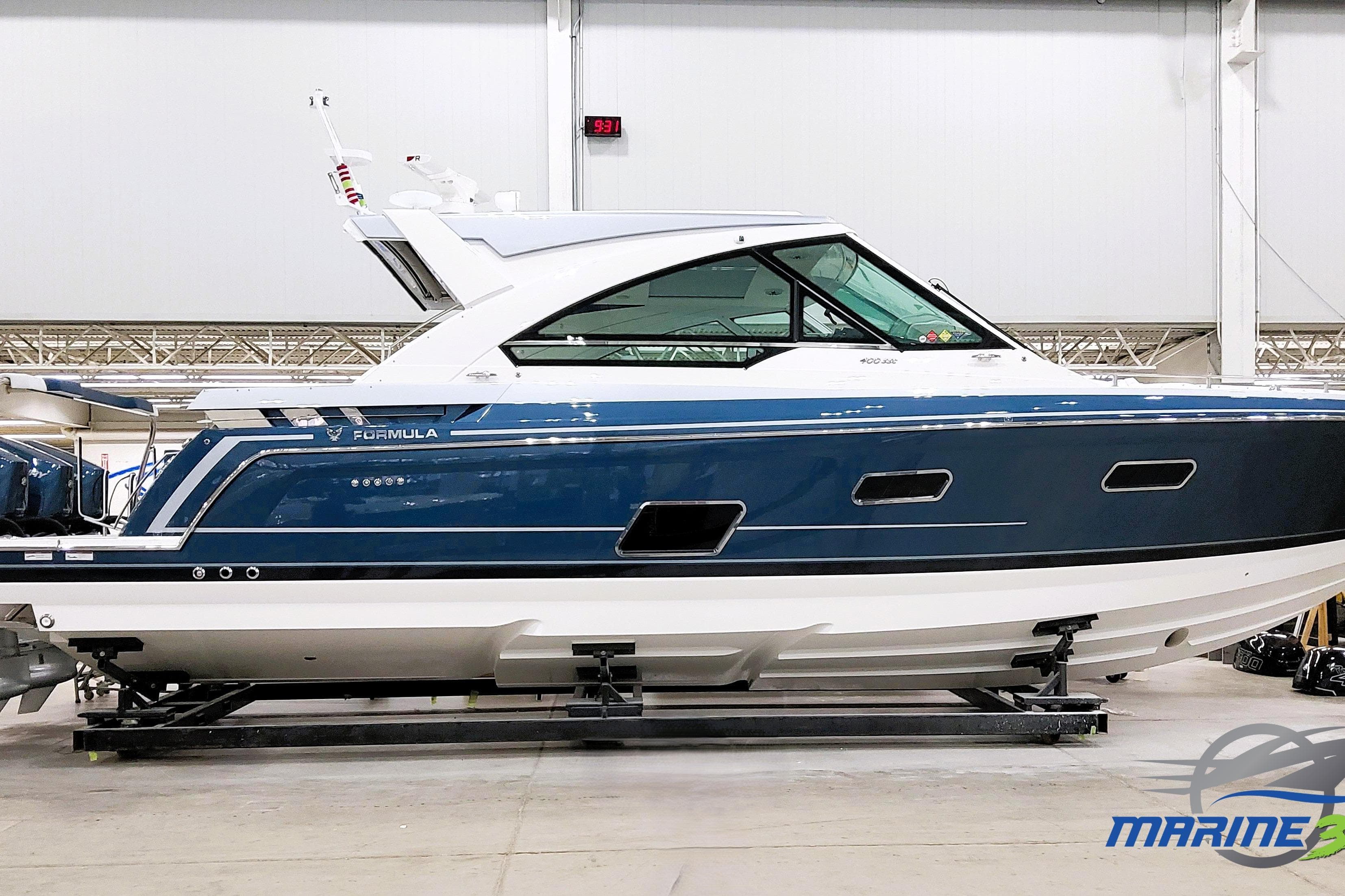 2026 Formula 400 Super Sport Crossover boat in a showroom, side view.
