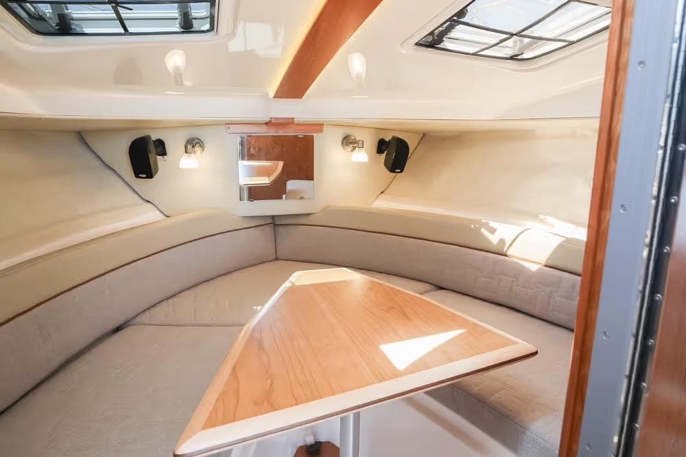 2026 Cutwater C-248 Coupe interior cabin with seating and wooden table.