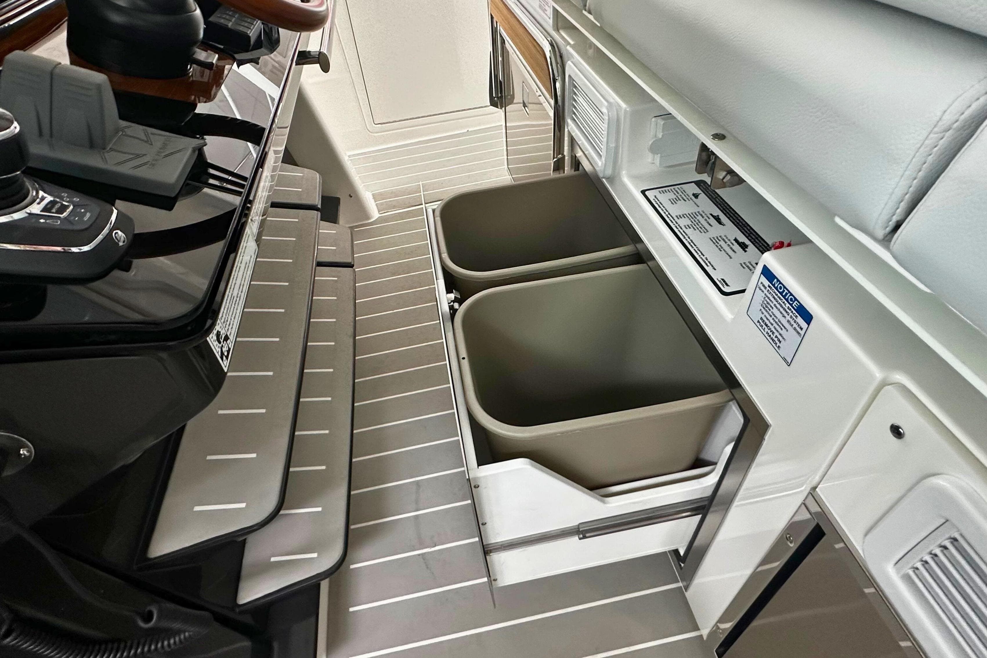 2026 Tiara Yachts 39 LS interior with dual storage bins and control panel.