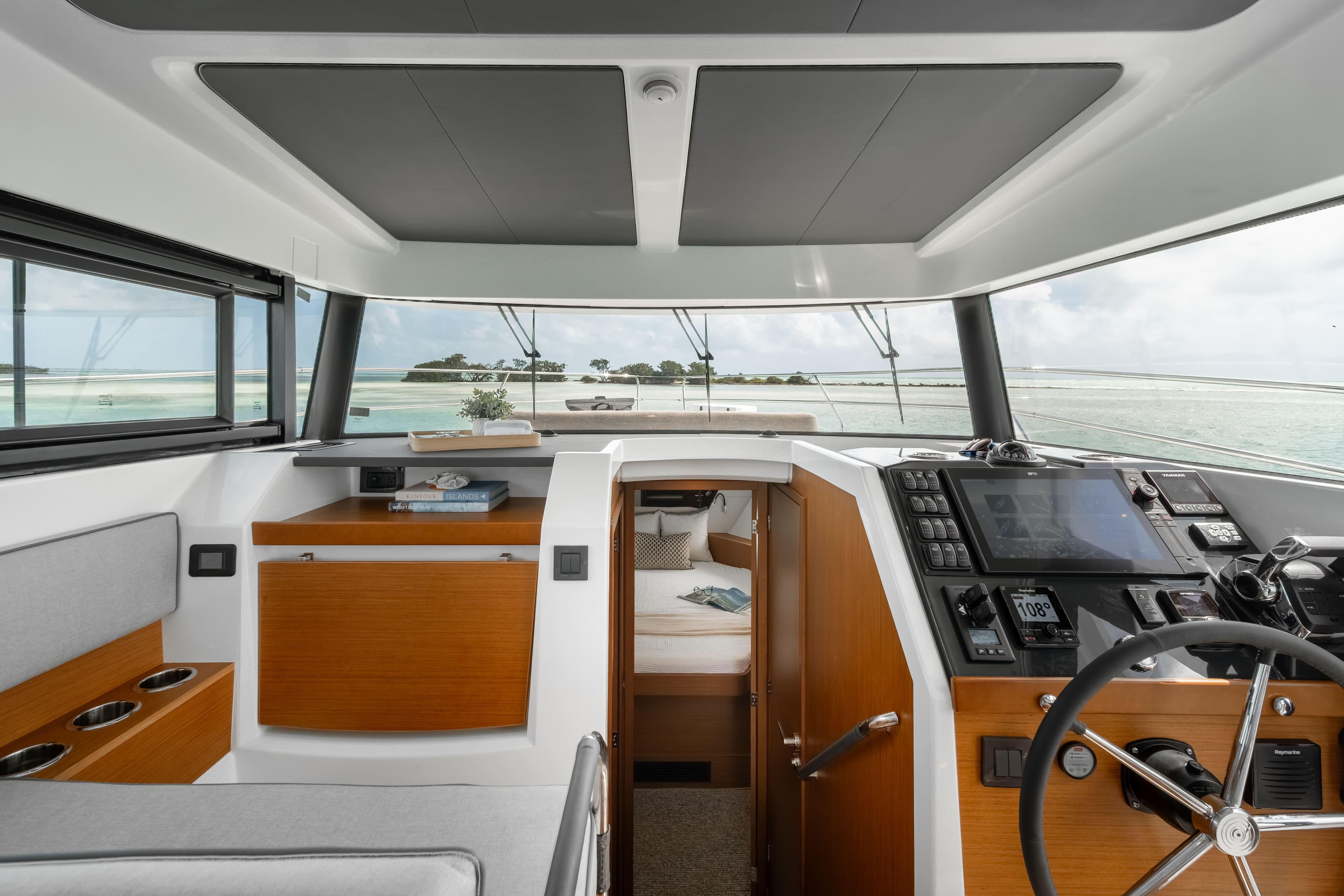 Interior of 2026 Beneteau Swift Trawler 37 Fly, featuring helm and cabin view.