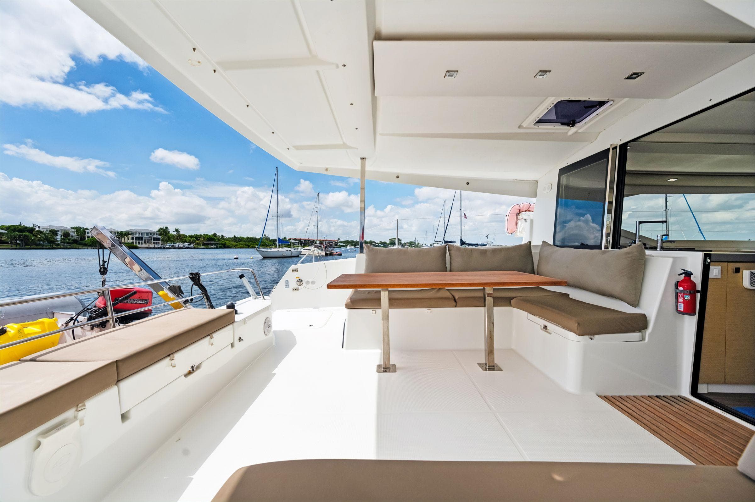 Spacious deck of 2018 Fountaine Pajot Lucia 40 catamaran with seating and table.