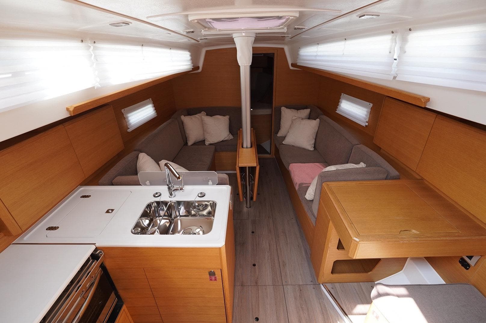 Modern interior of 2022 Elan E4 yacht with kitchen and seating area.