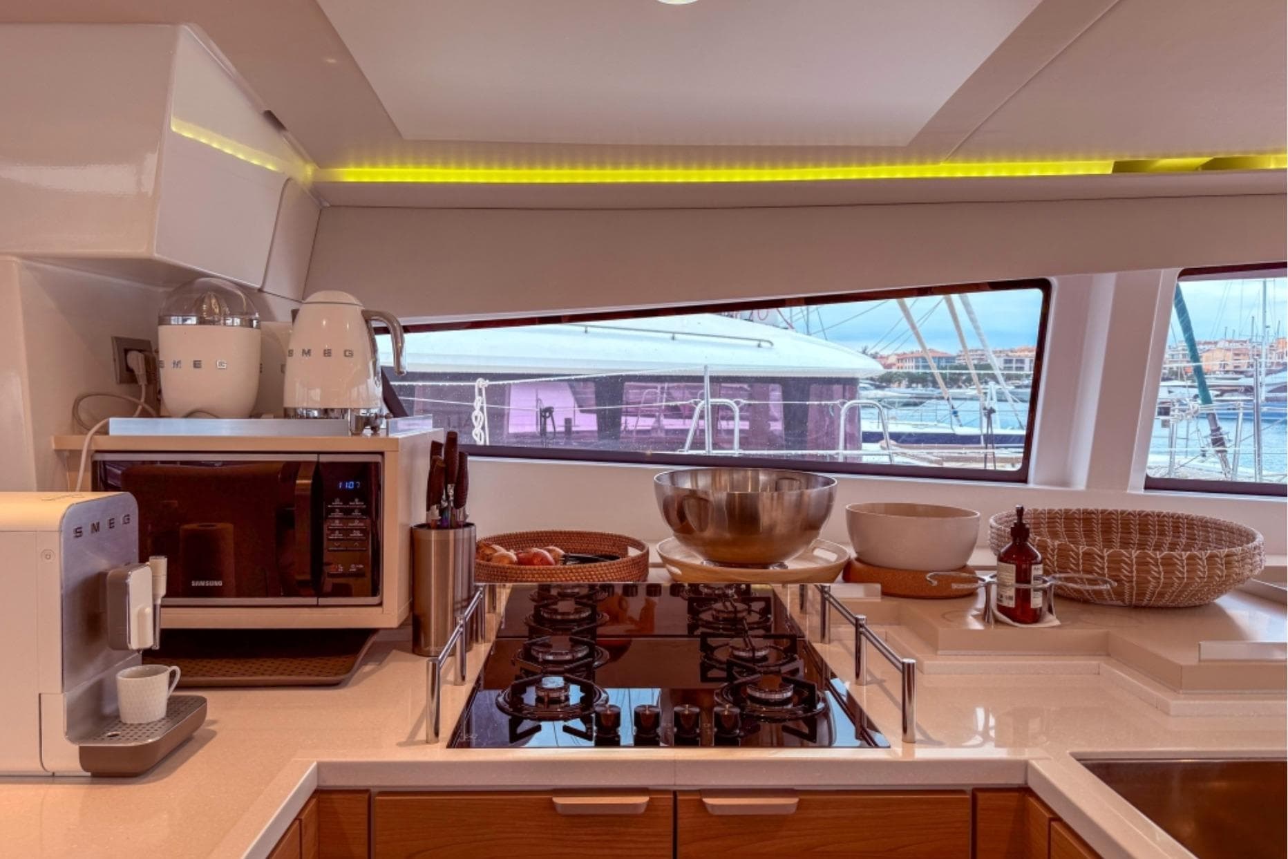 Modern kitchen on 2023 Bali 5.4 yacht with appliances and marina view.