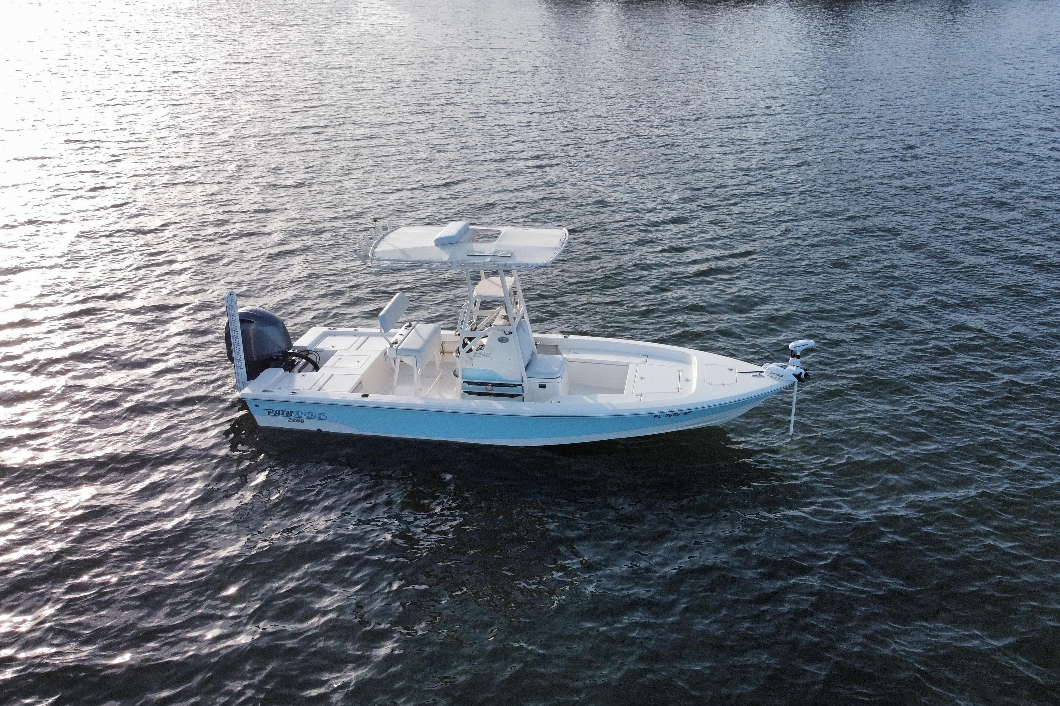 2017 Pathfinder 2200 TRS boat on calm water, side view.