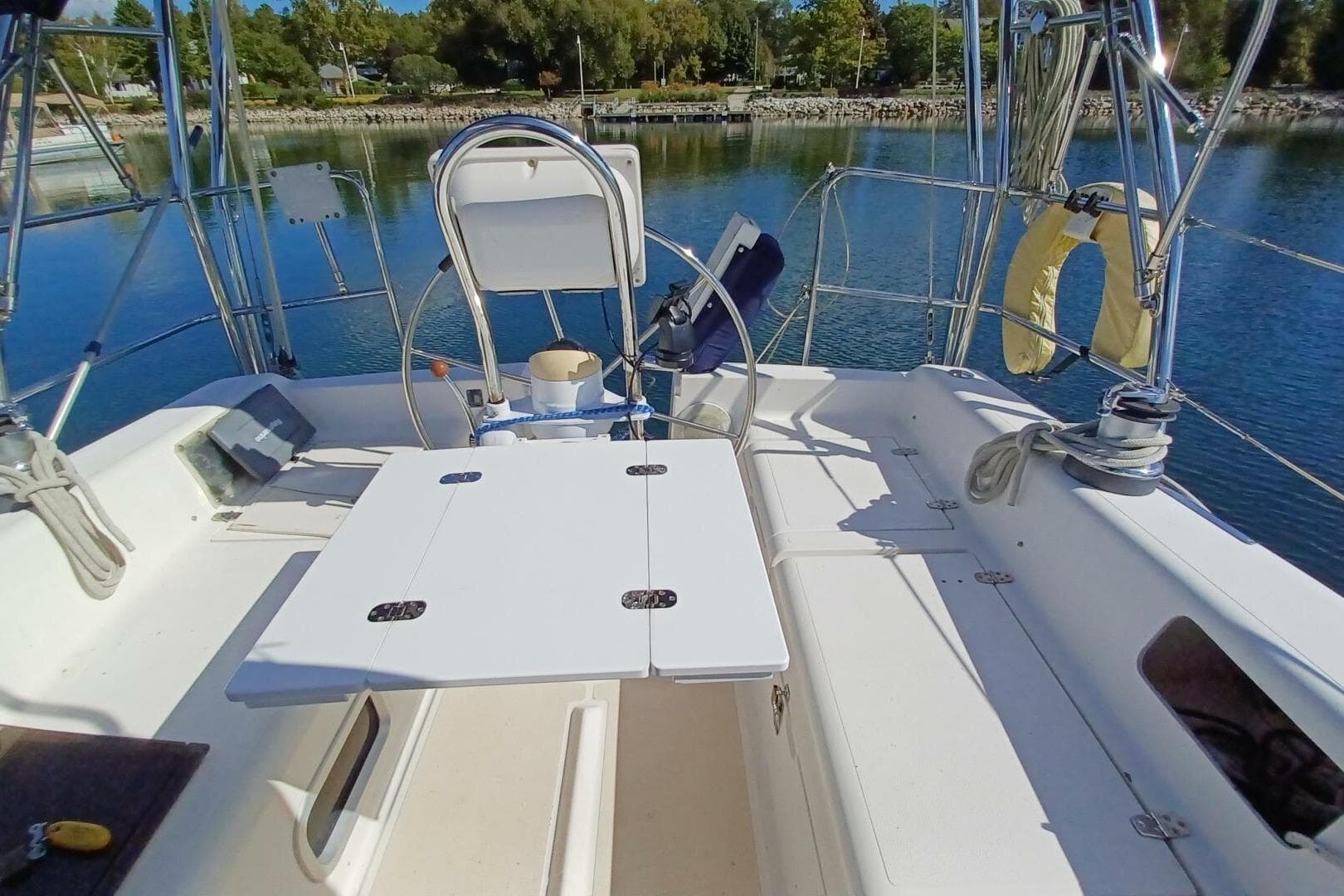 Cockpit of 2000 Saga 35 sailboat with steering wheel and foldable table.