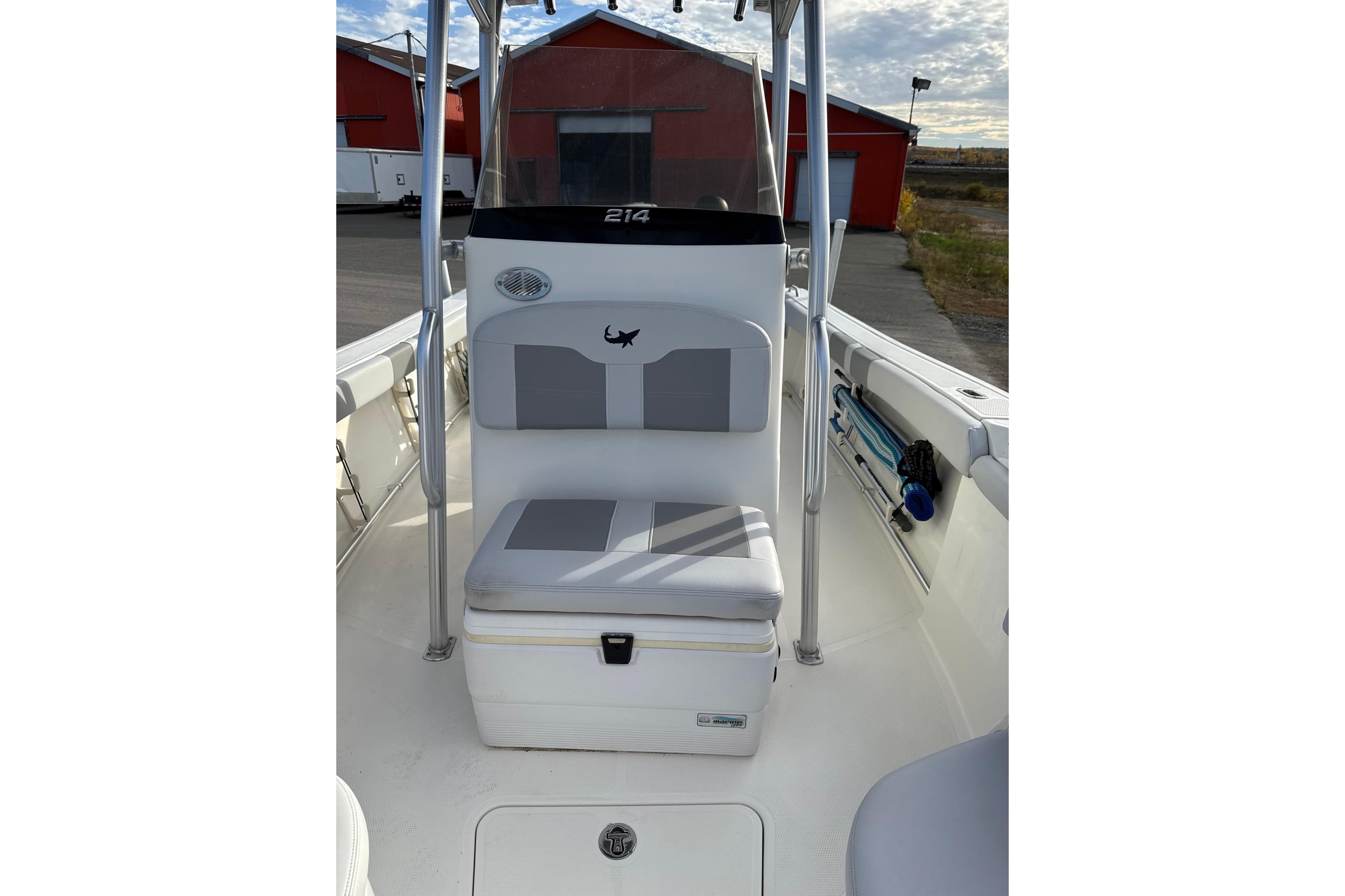 2020 Mako 214 Center Console boat interior with cushioned seating and storage.