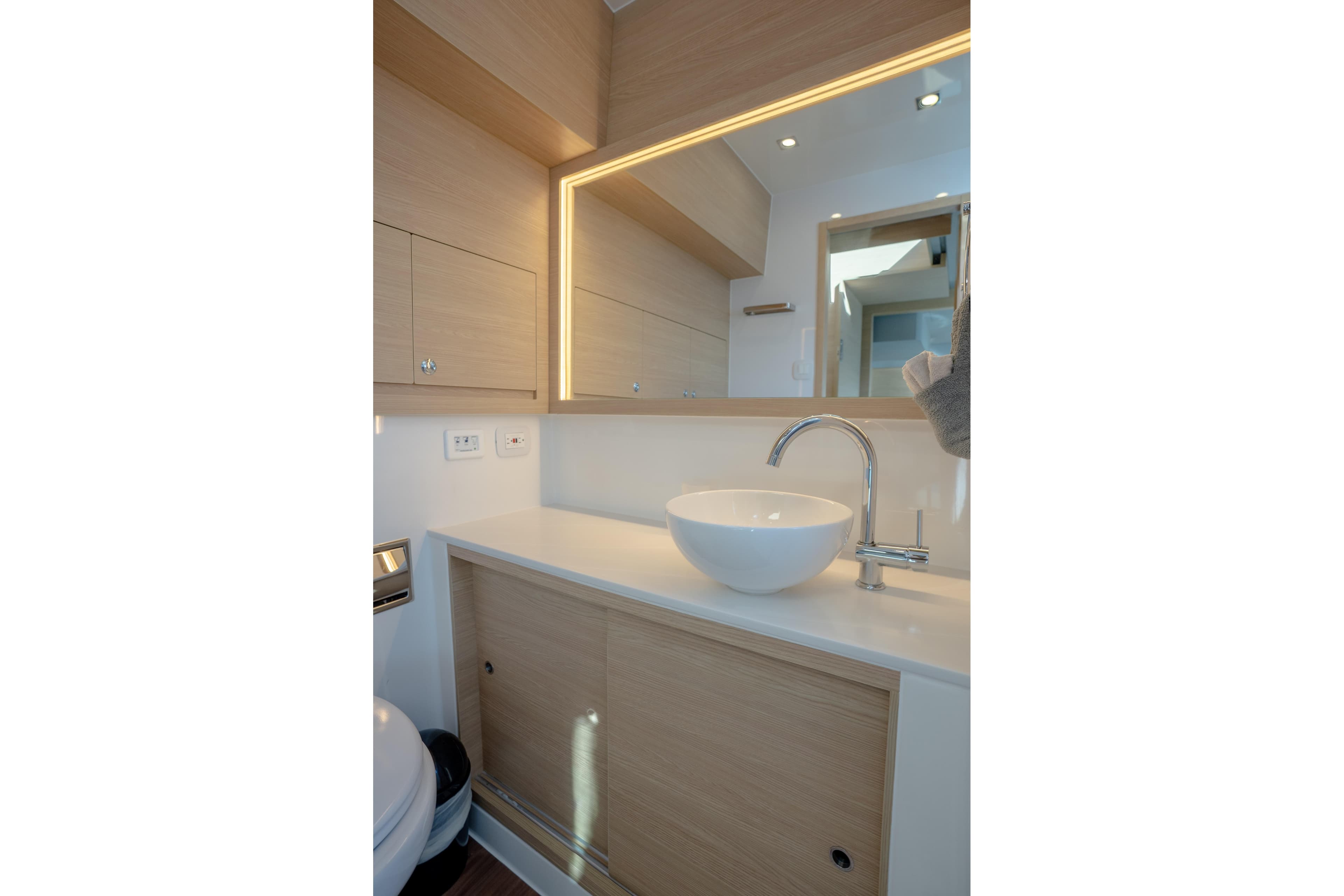 Modern bathroom interior on 2025 Aquila 54 Yacht with sleek sink and mirror.