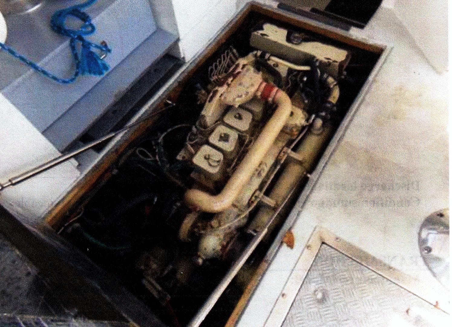 Engine compartment of a 1999 Custom 30 Novi Hardtop Cruiser, showcasing mechanical components.
