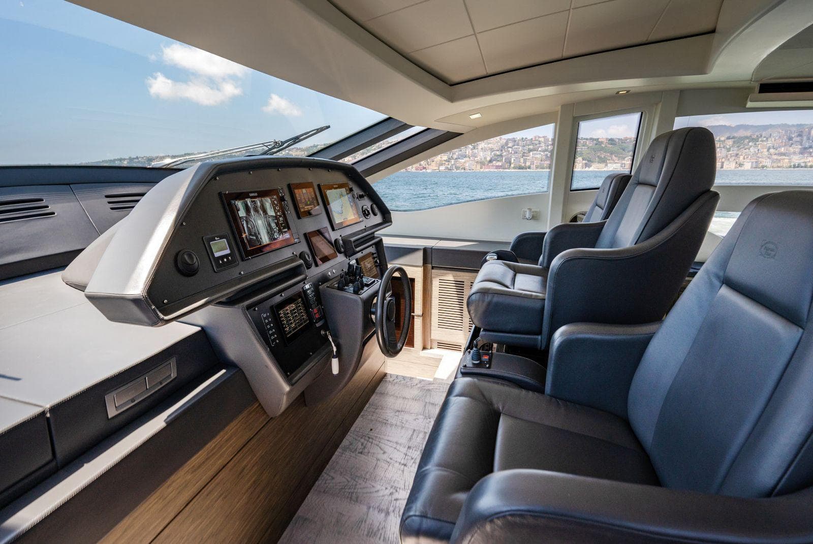 Luxurious 2019 Pershing 82 yacht cockpit with modern navigation systems and plush seating.