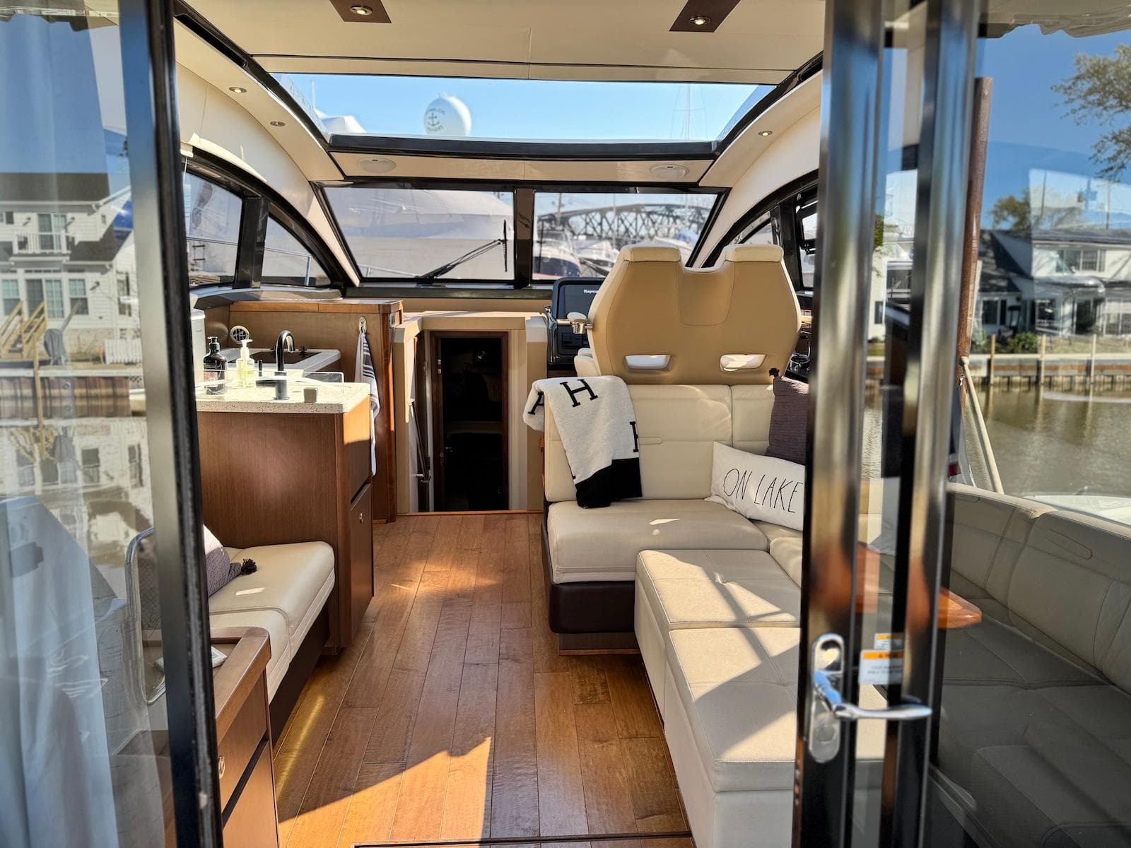 Luxurious interior of 2016 Sea Ray 400 Sundancer yacht with modern furnishings and panoramic windows.