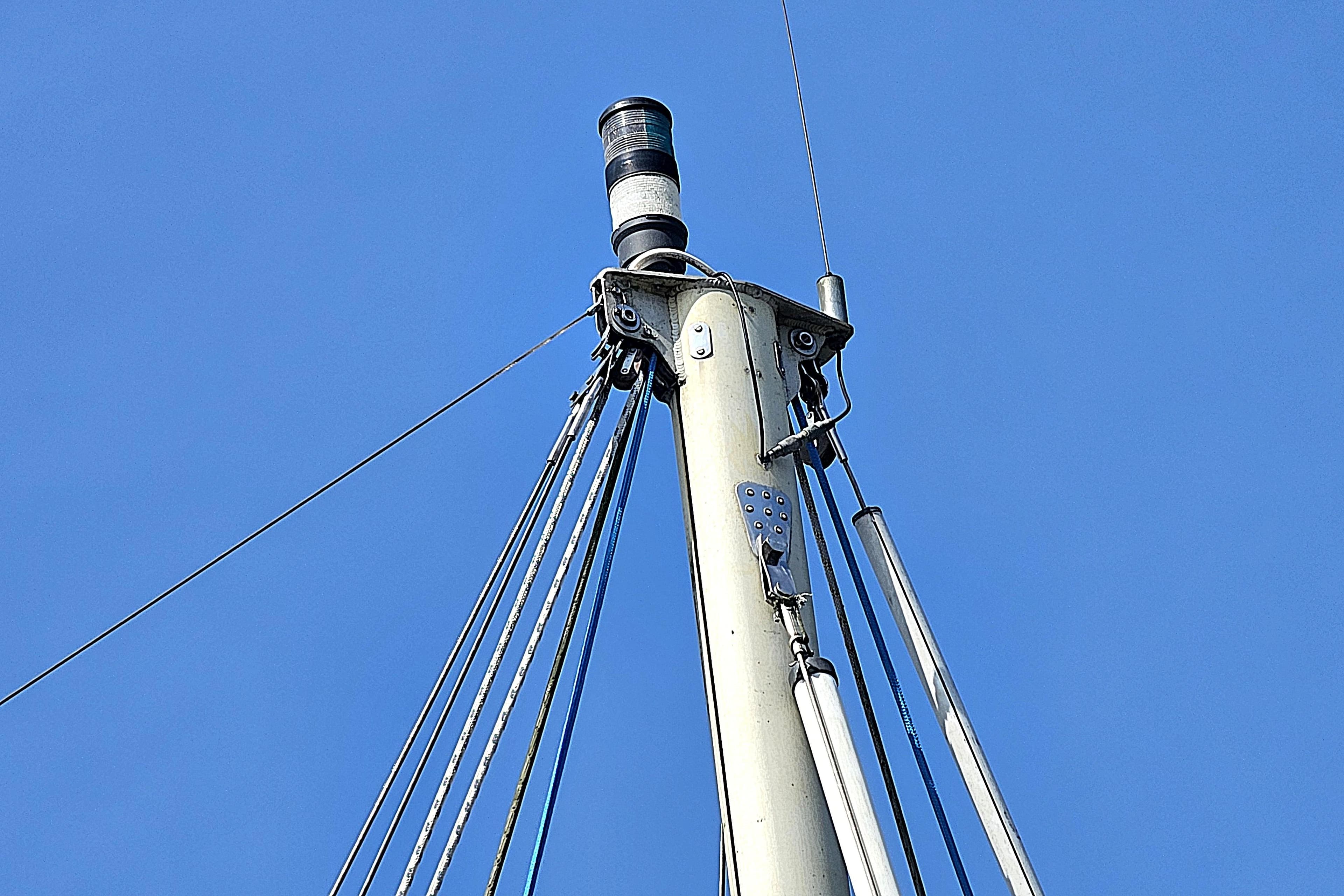 Mast top of 1974 Fairways Marine Fisher 30 sailboat against clear blue sky.