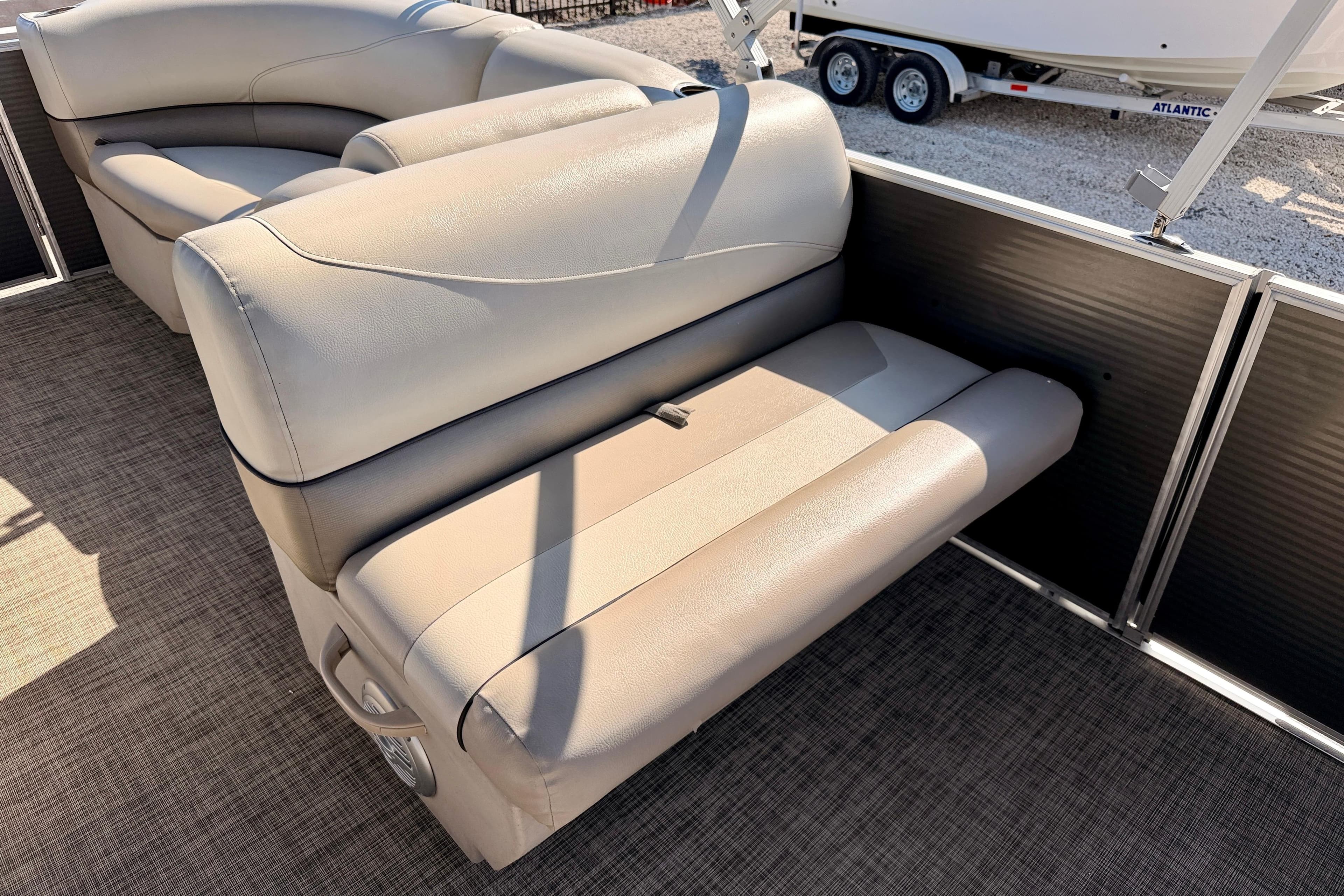 Luxurious seating on 2022 Cypress Cay Seabreeze 232 pontoon boat, featuring plush beige upholstery.
