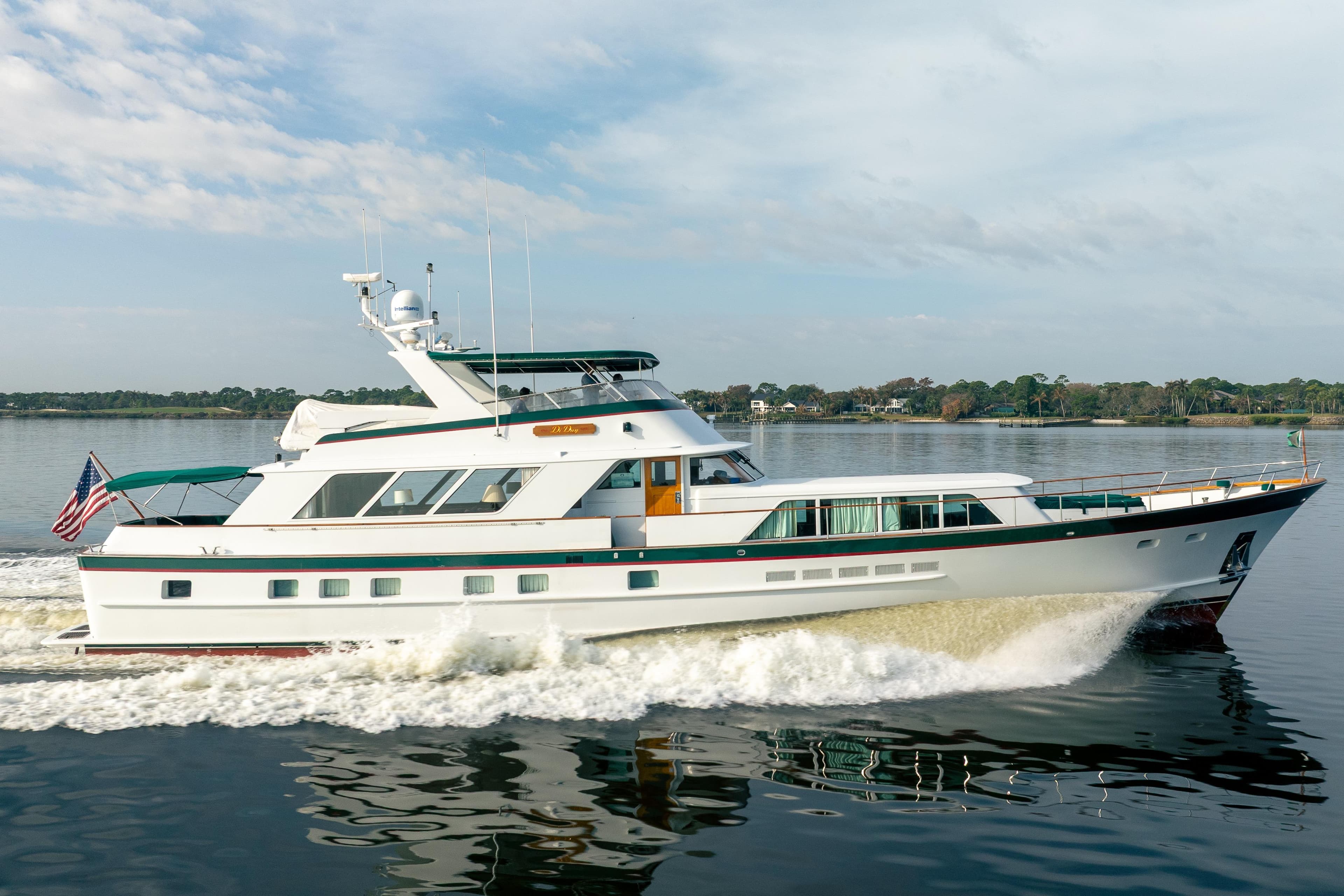Luxury 1983 Burger 91 yacht cruising on calm waters, showcasing elegant design.