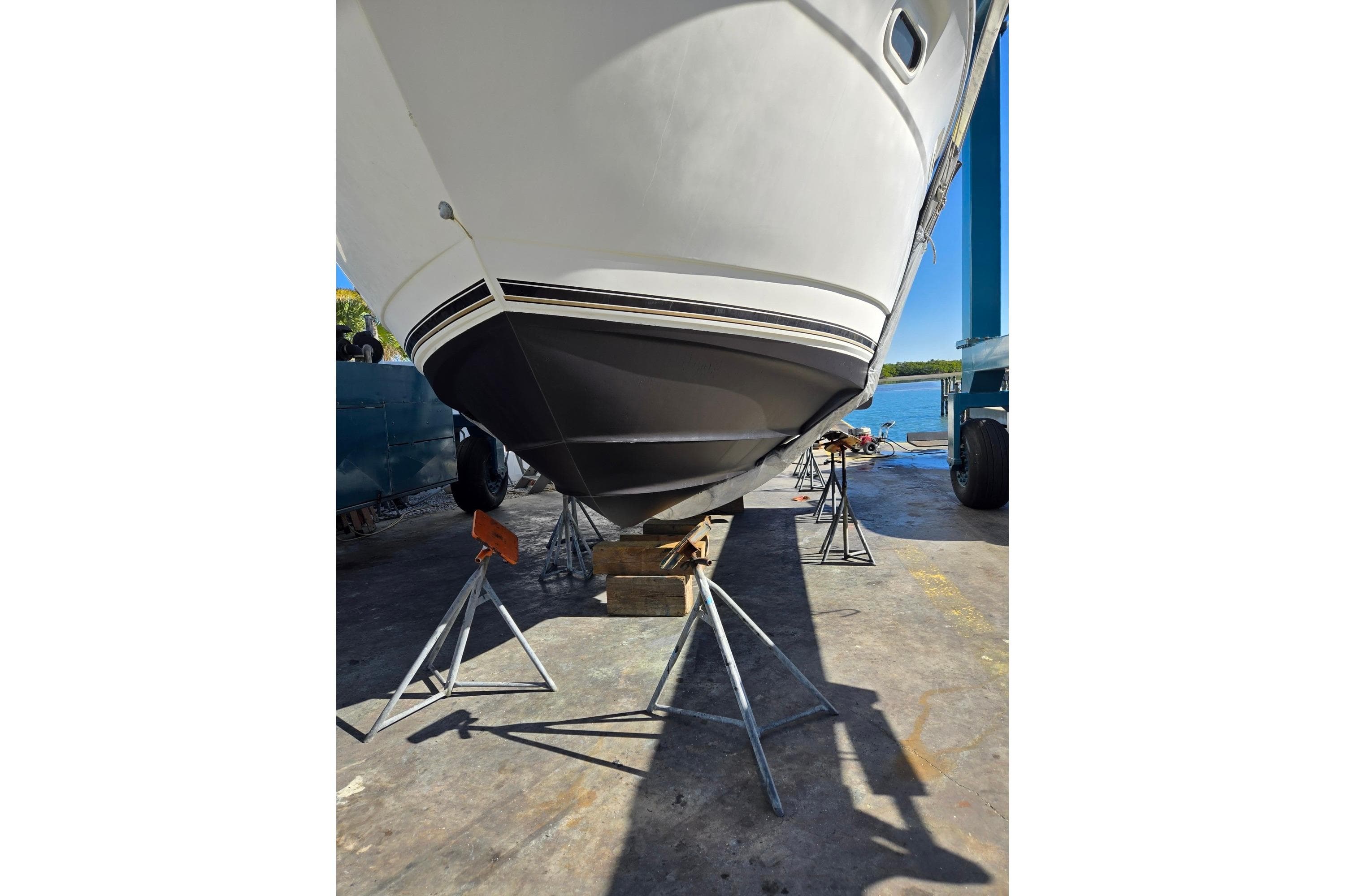 2004 Cruisers Yachts 3750 Motoryacht on stands, hull view, outdoor setting.