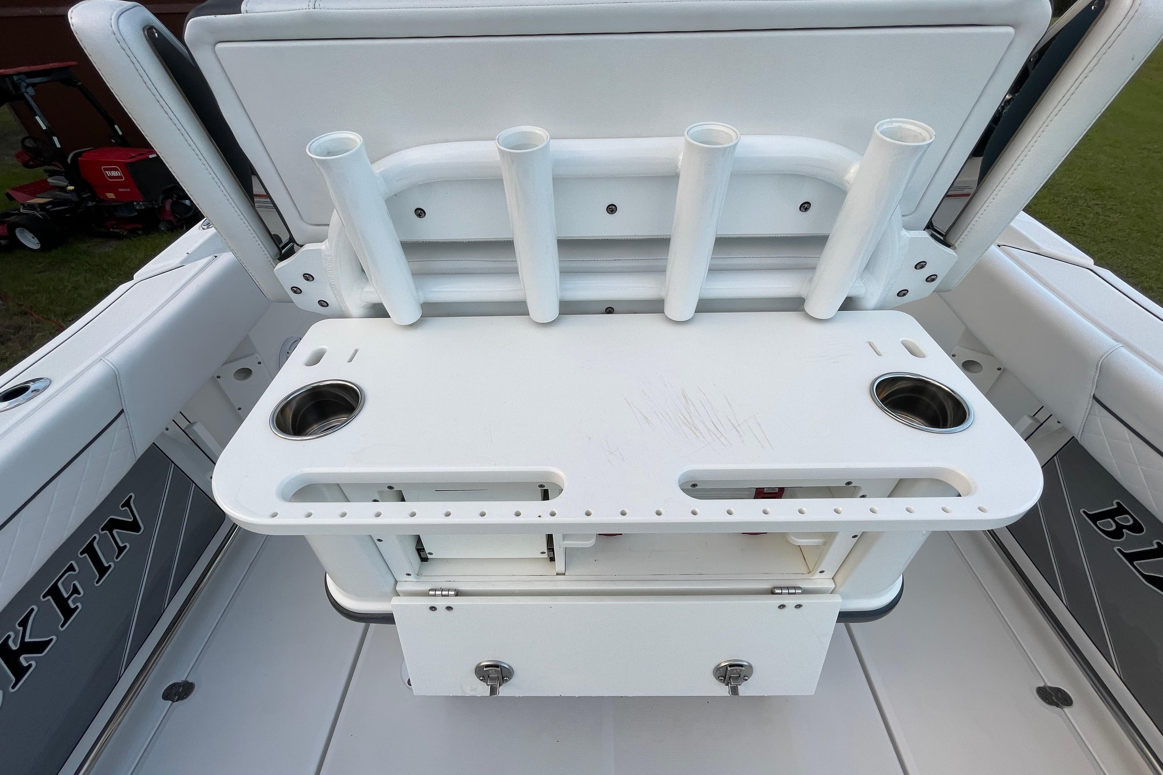 2022 Blackfin 252 CC boat with rod holders and storage compartment.
