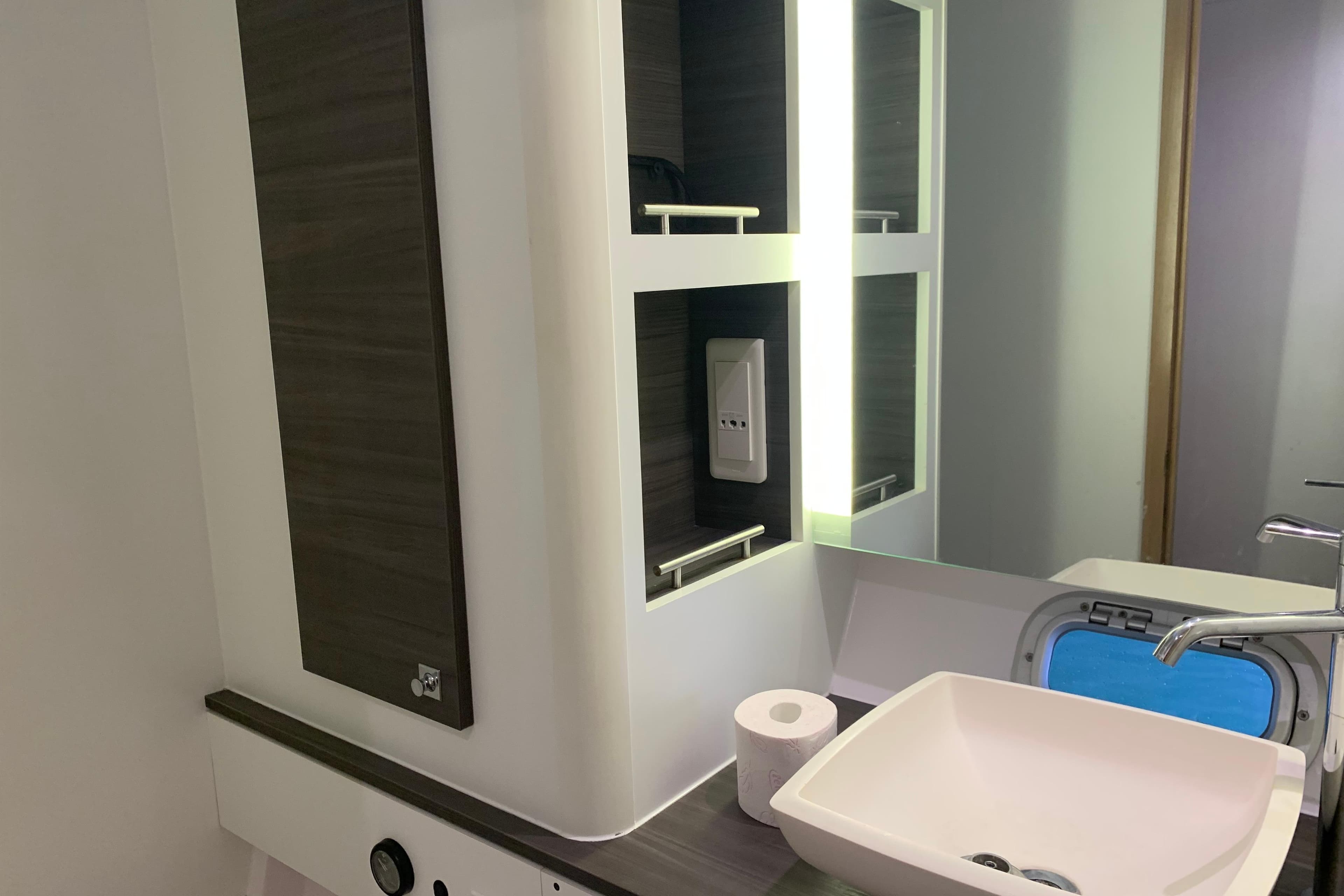 Modern bathroom interior of 2021 Outremer 51 yacht with sink and mirror.