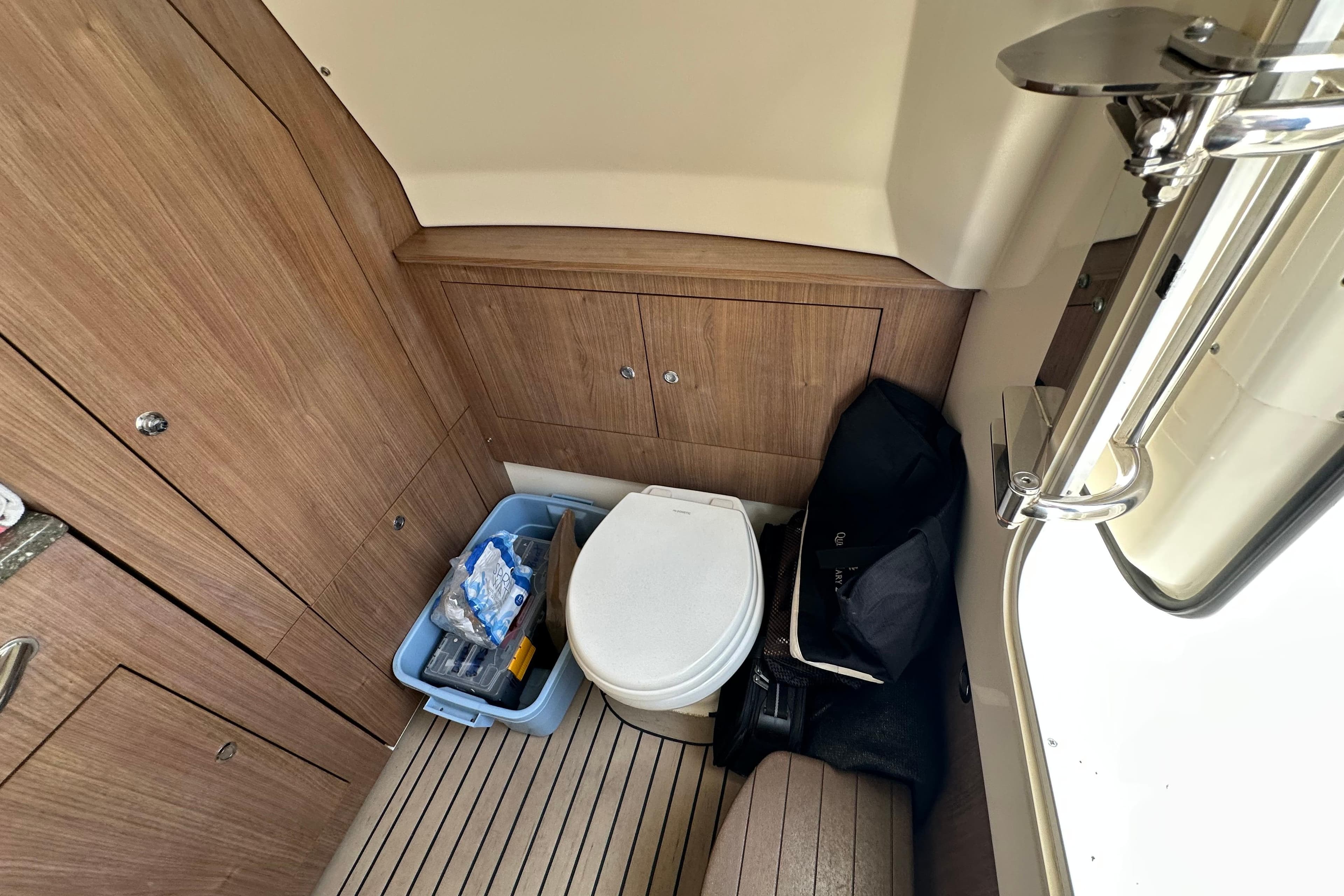 2018 Boston Whaler 350 Outrage cabin interior with toilet and storage area.