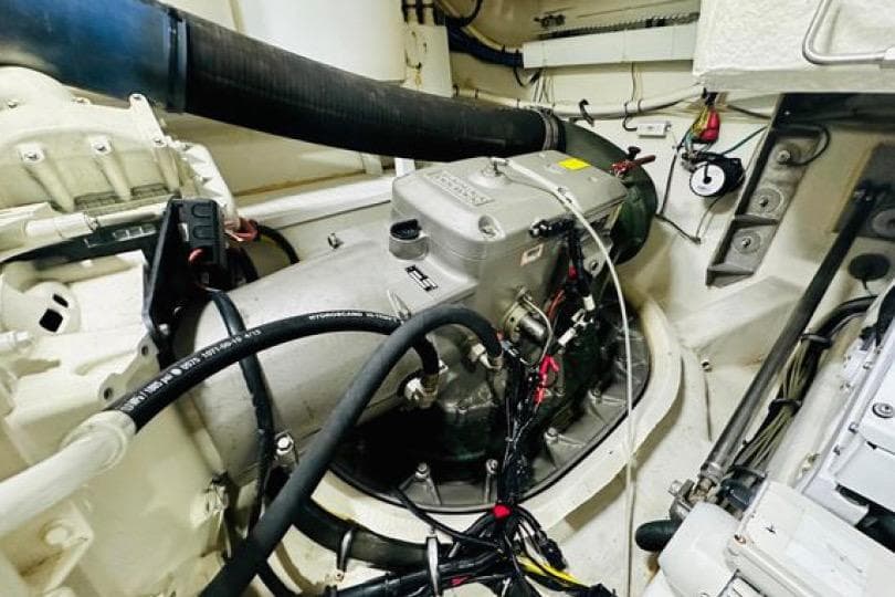 Engine room of 2017 Cruisers Yachts 60 Fly, showcasing mechanical components and wiring.